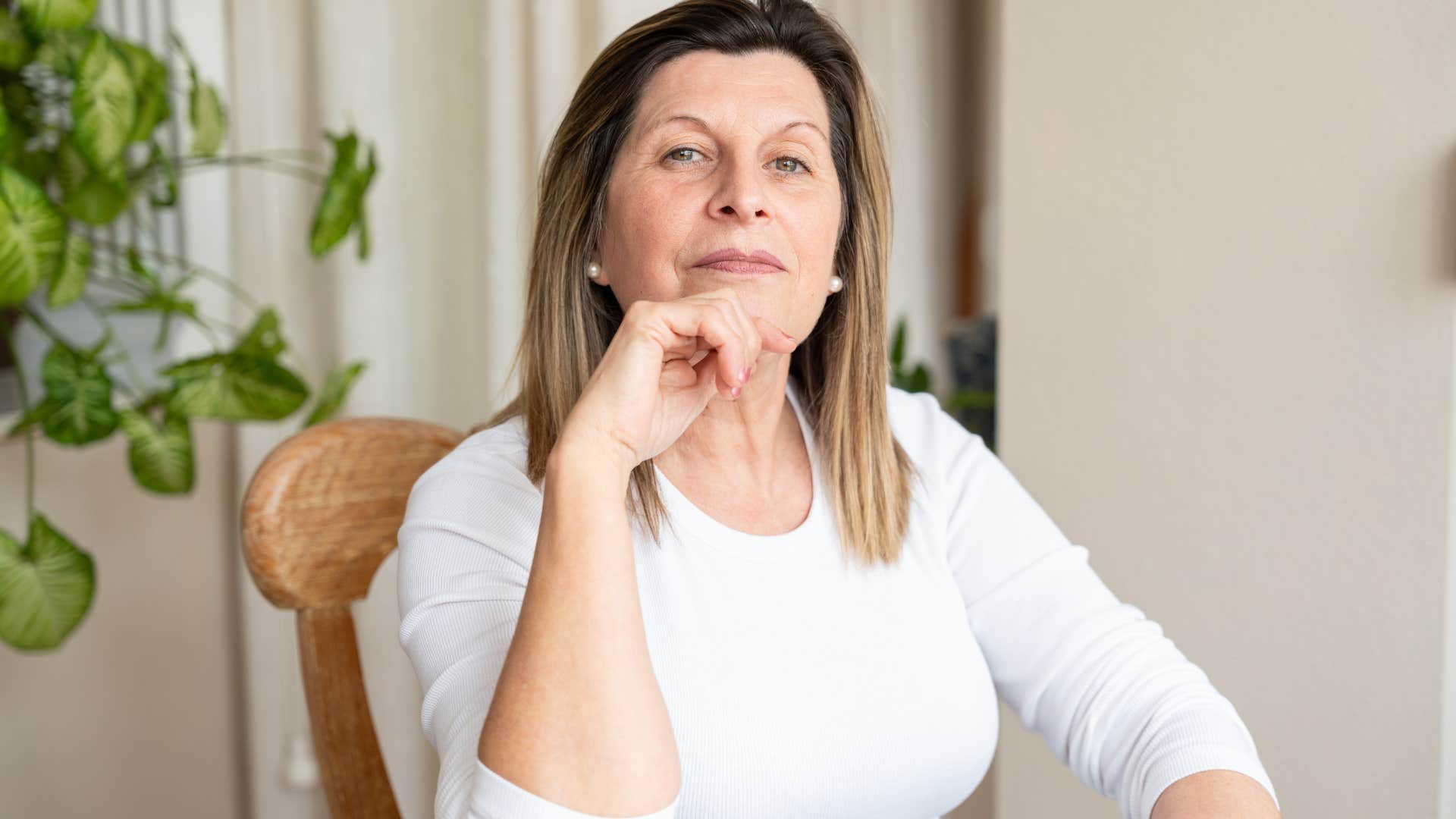 serious woman sitting in chair hating feeling trapped
