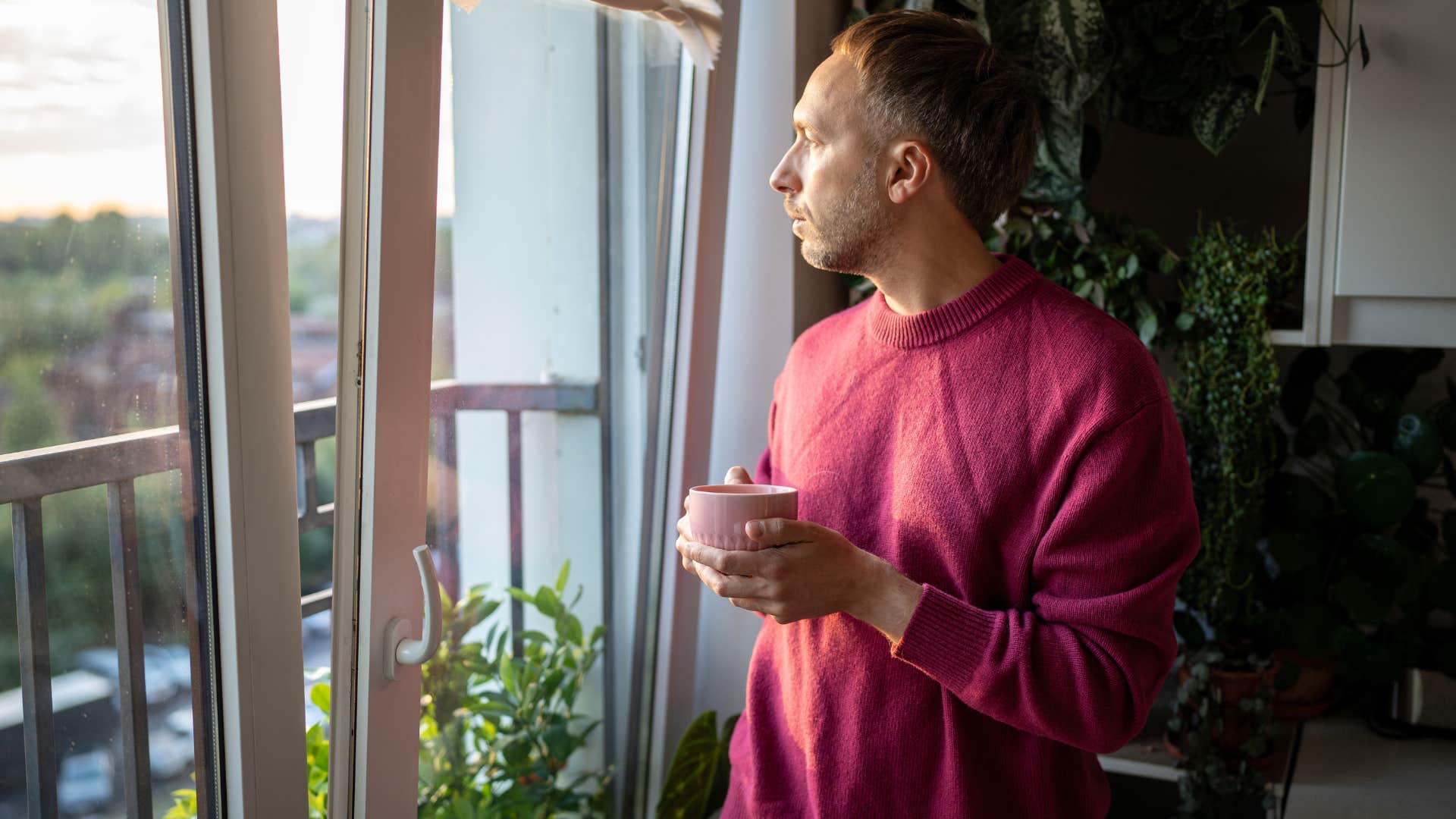 man standing by open door for fresh air