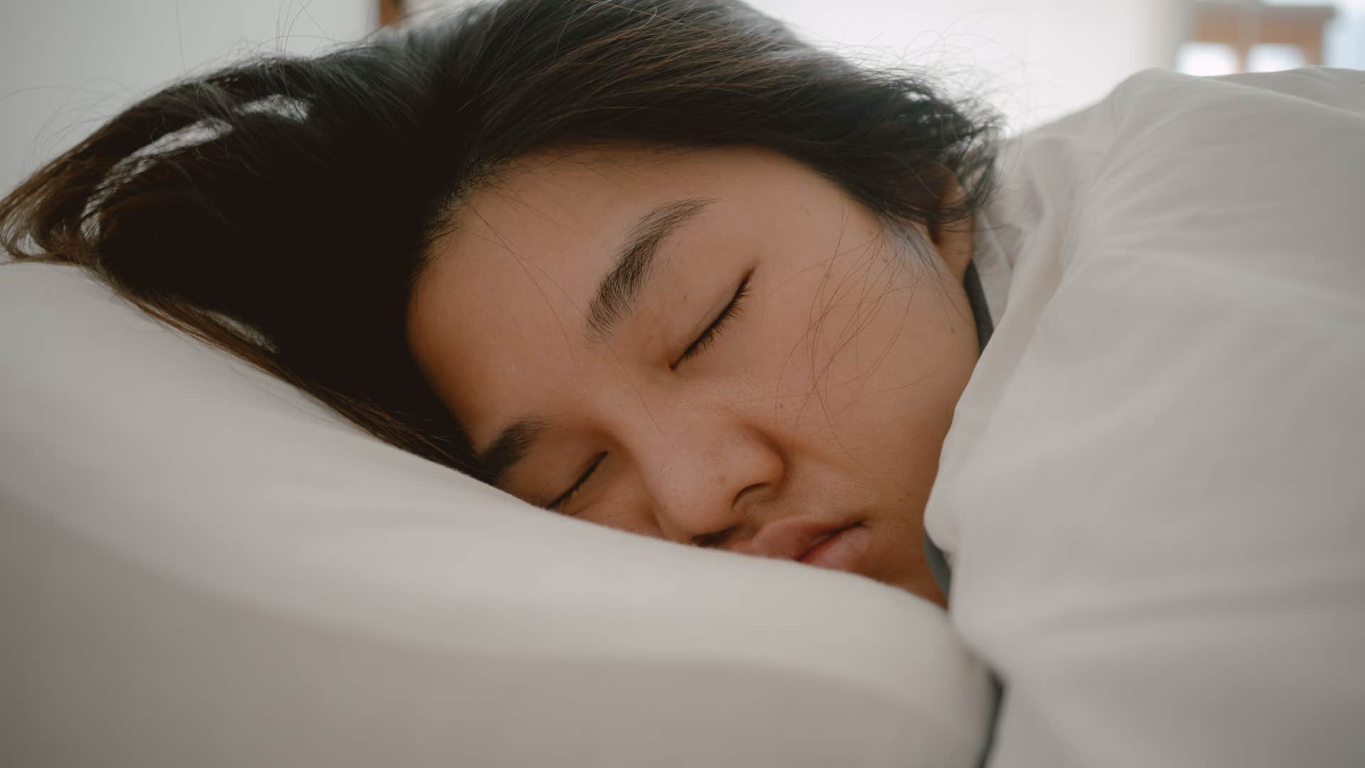 woman sleeping deeply in bed