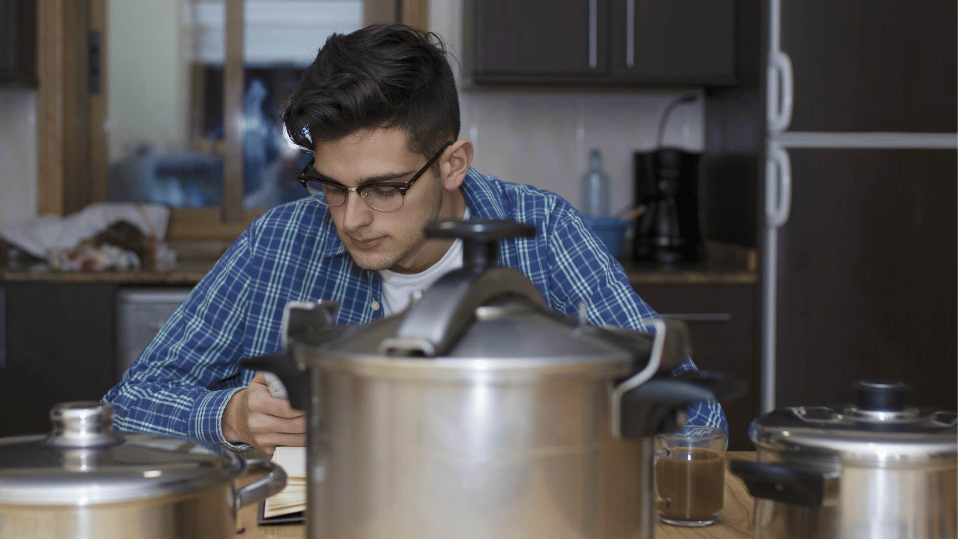 man sitting with cookware around him