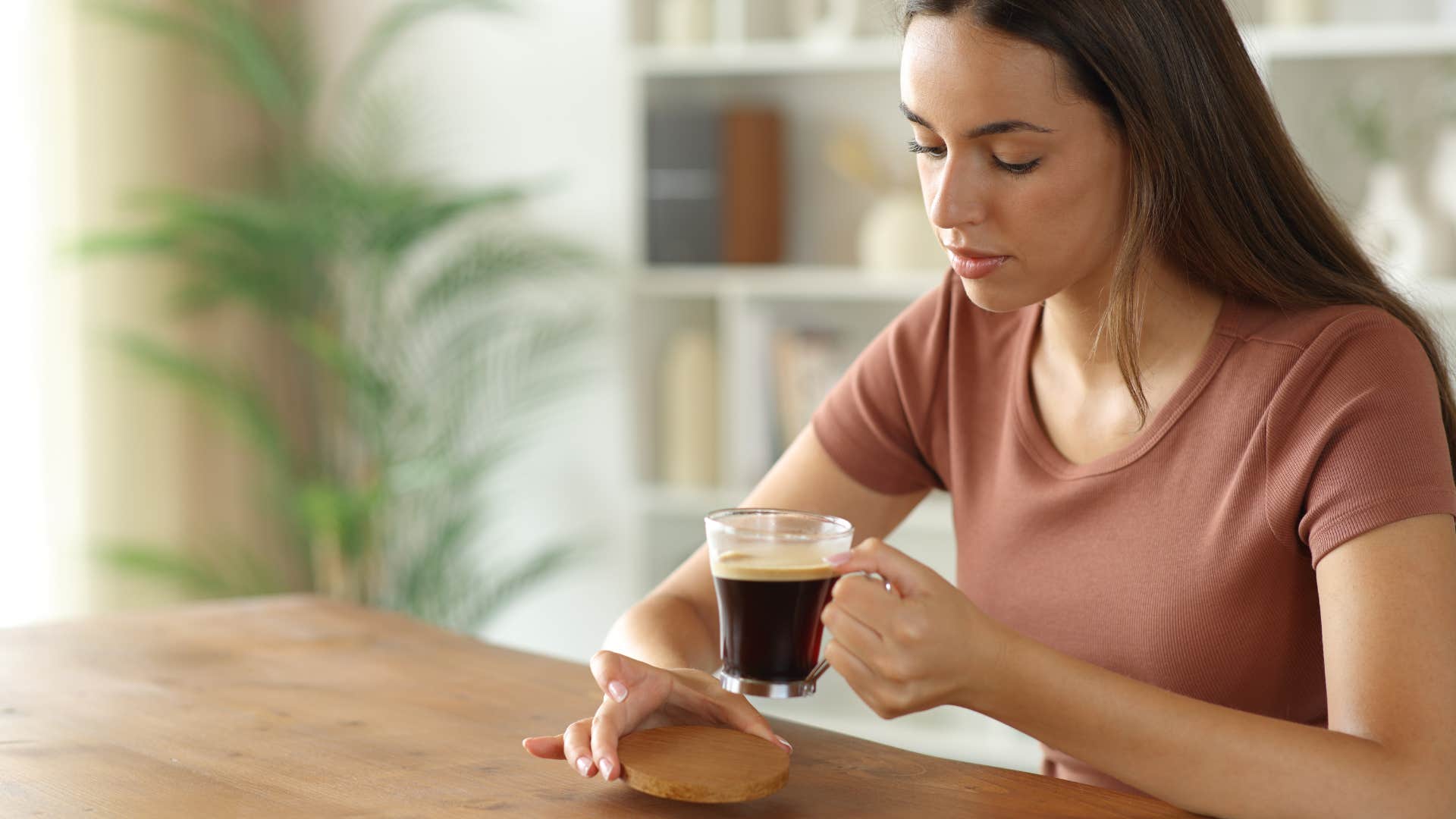 woman using coaster for her coffee