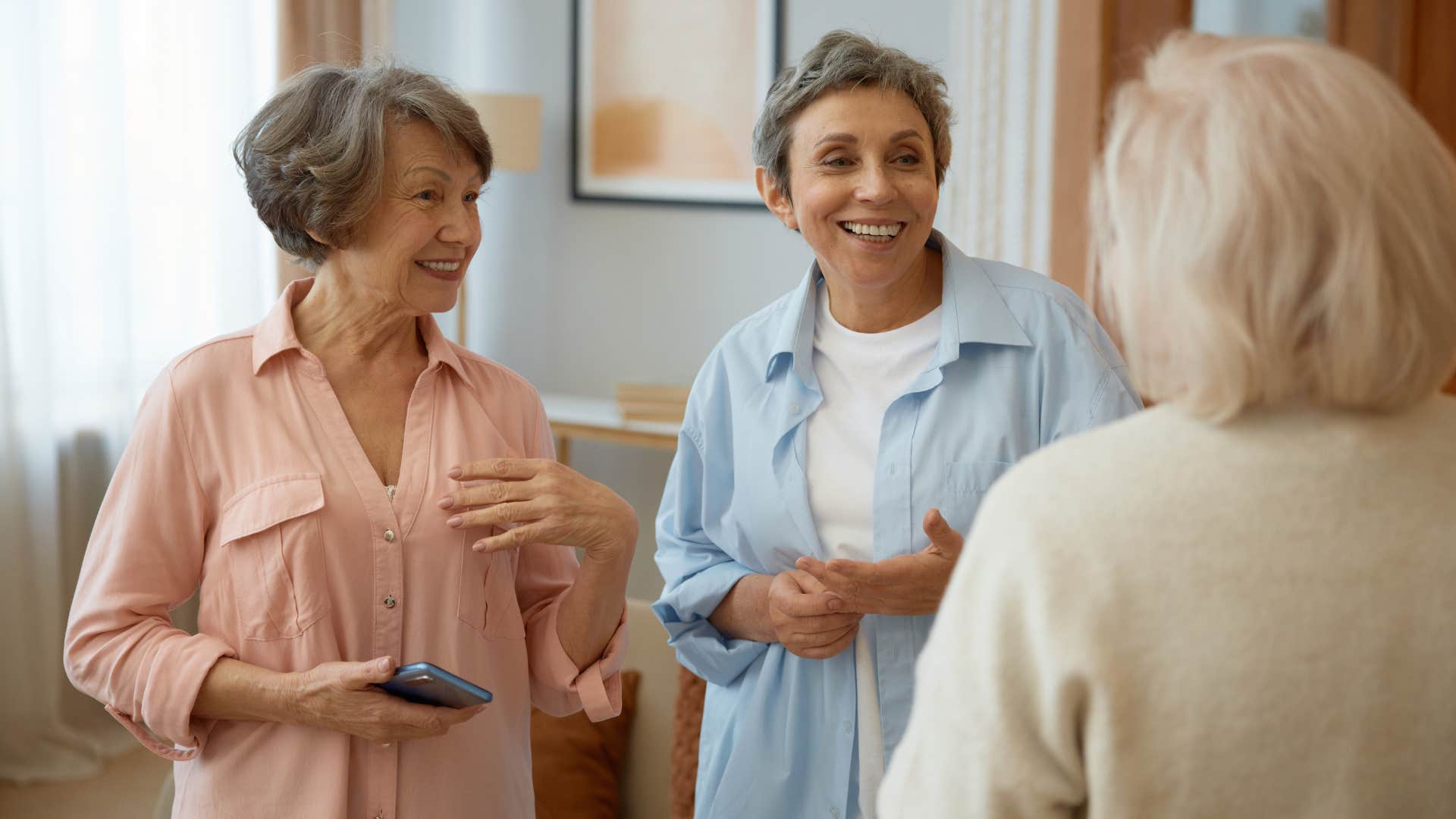 older woman talking to friends about her children