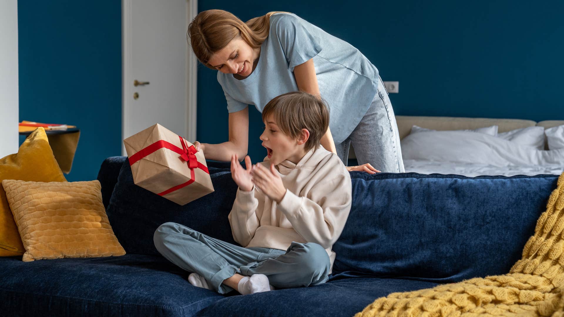 mom giving excited son gift