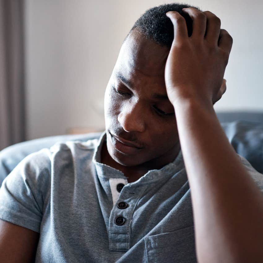 Man sitting in a cold, impersonal room at home.