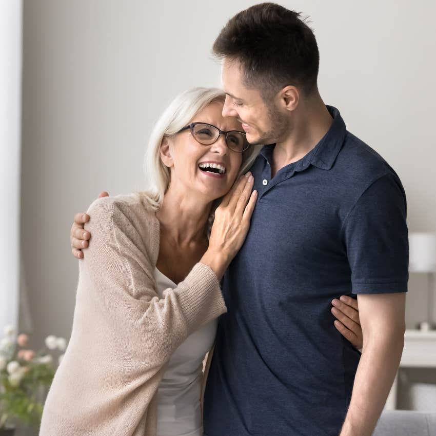 Woman smiling with her son who comes to visit without expectations.