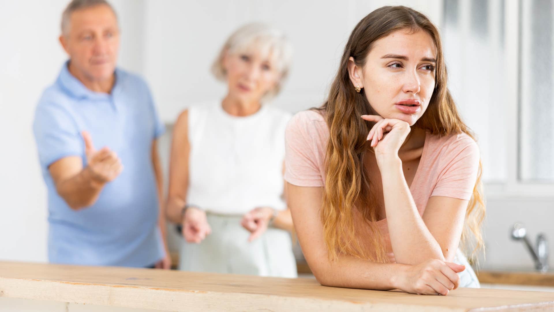 Upset woman saying "stop acting like you care" to her parents.
