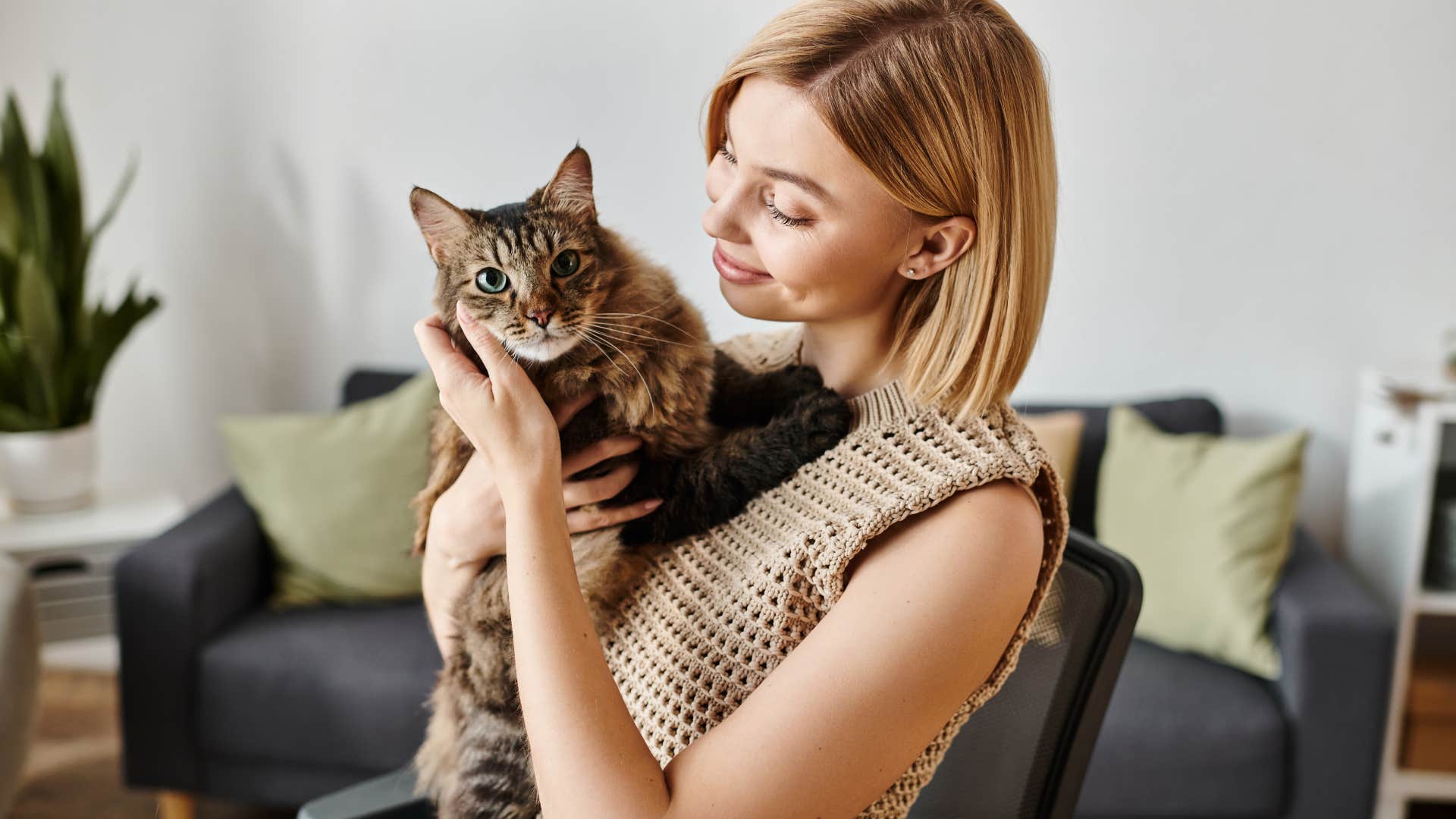 woman holding her cat looking at it lovingly