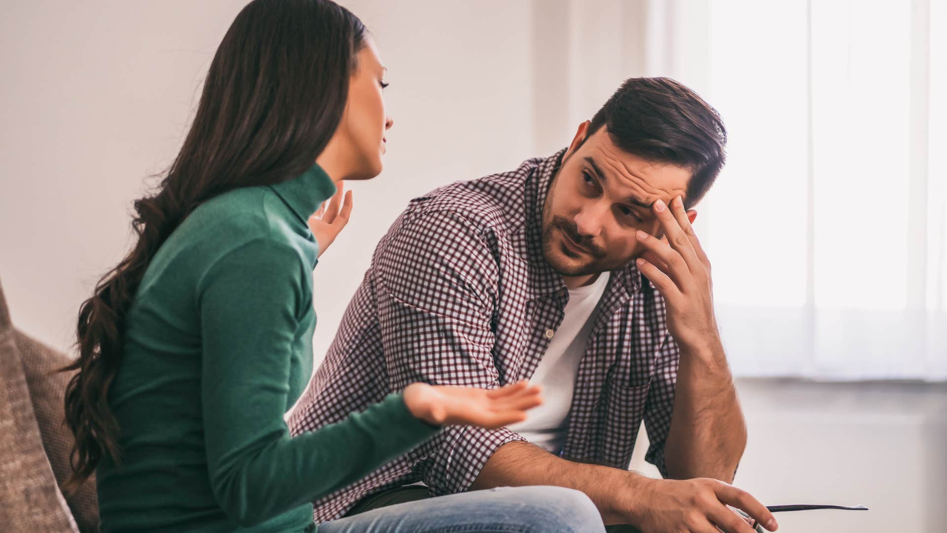 man having argument with his partner at home