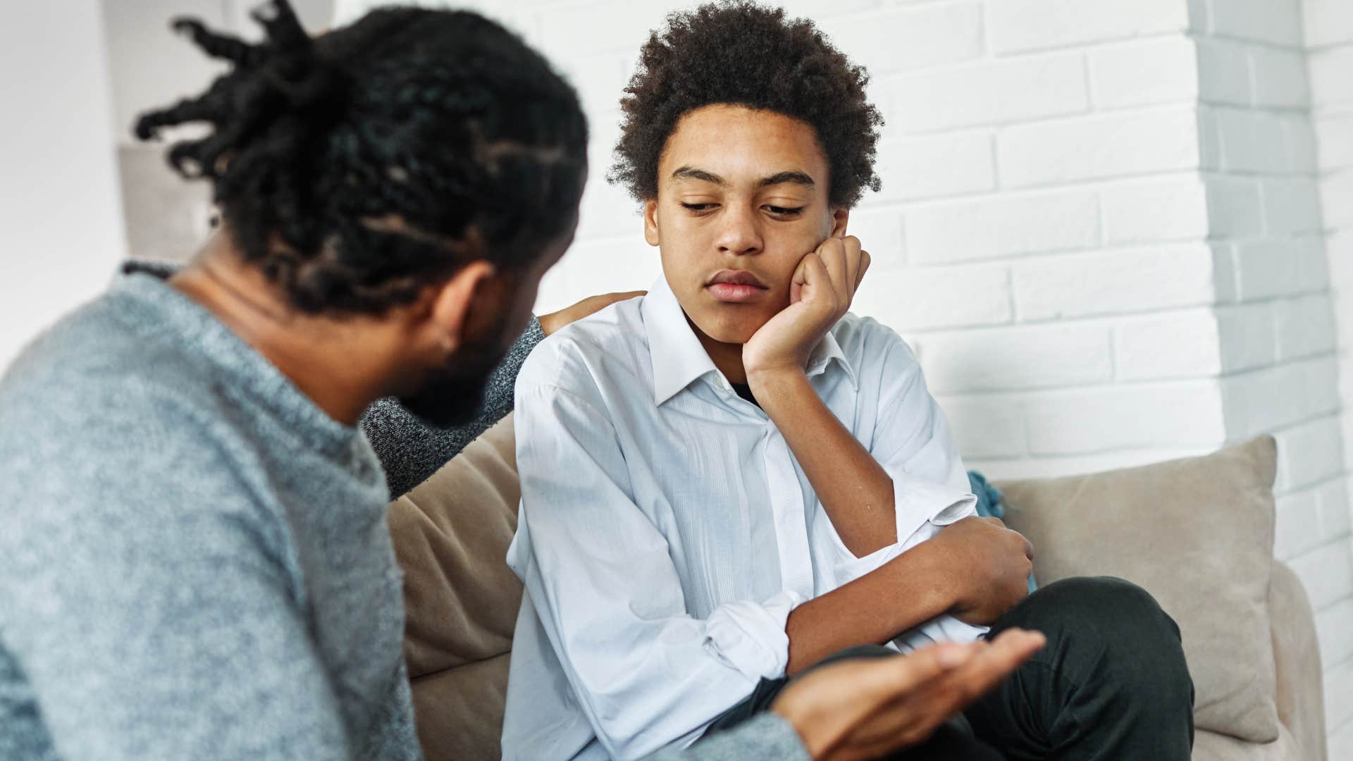 father in a disciplinary moment with his teenage son