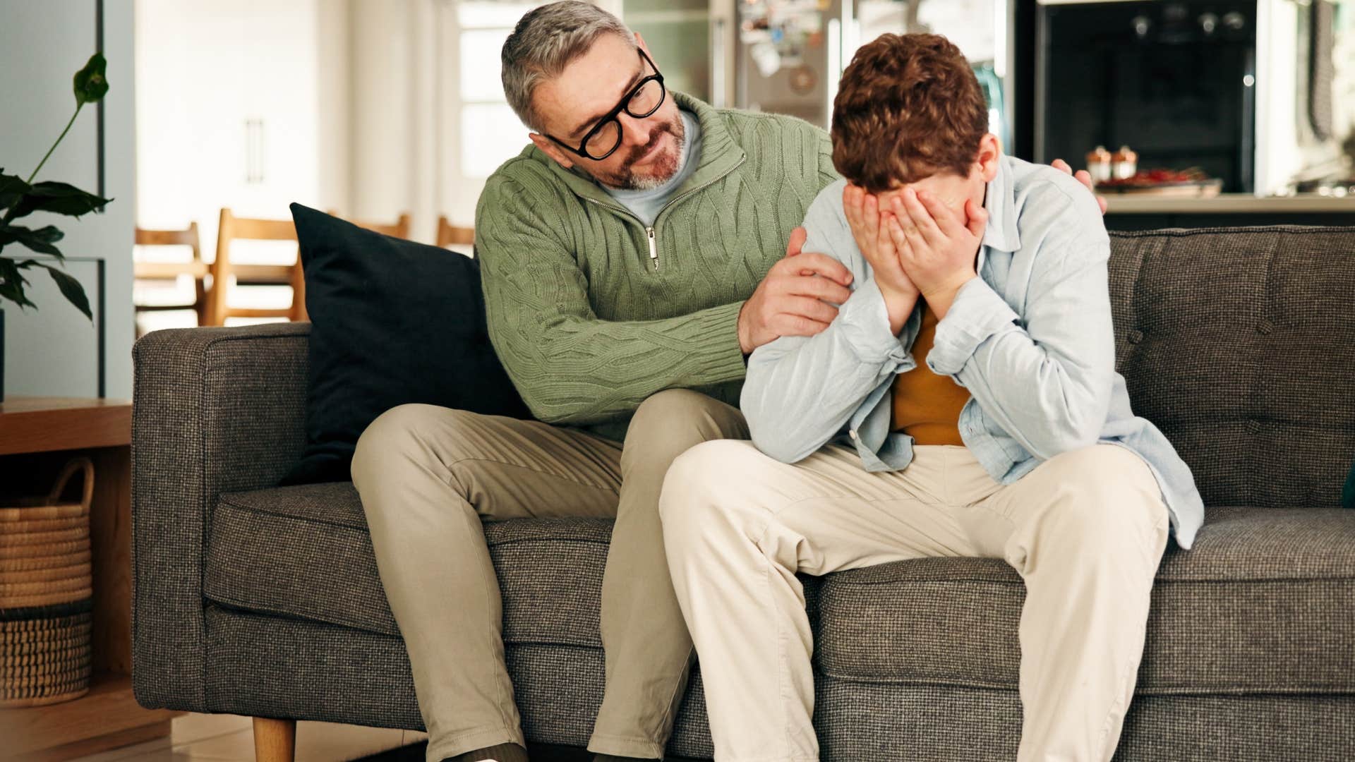 father having vulnerable conversation with upset son