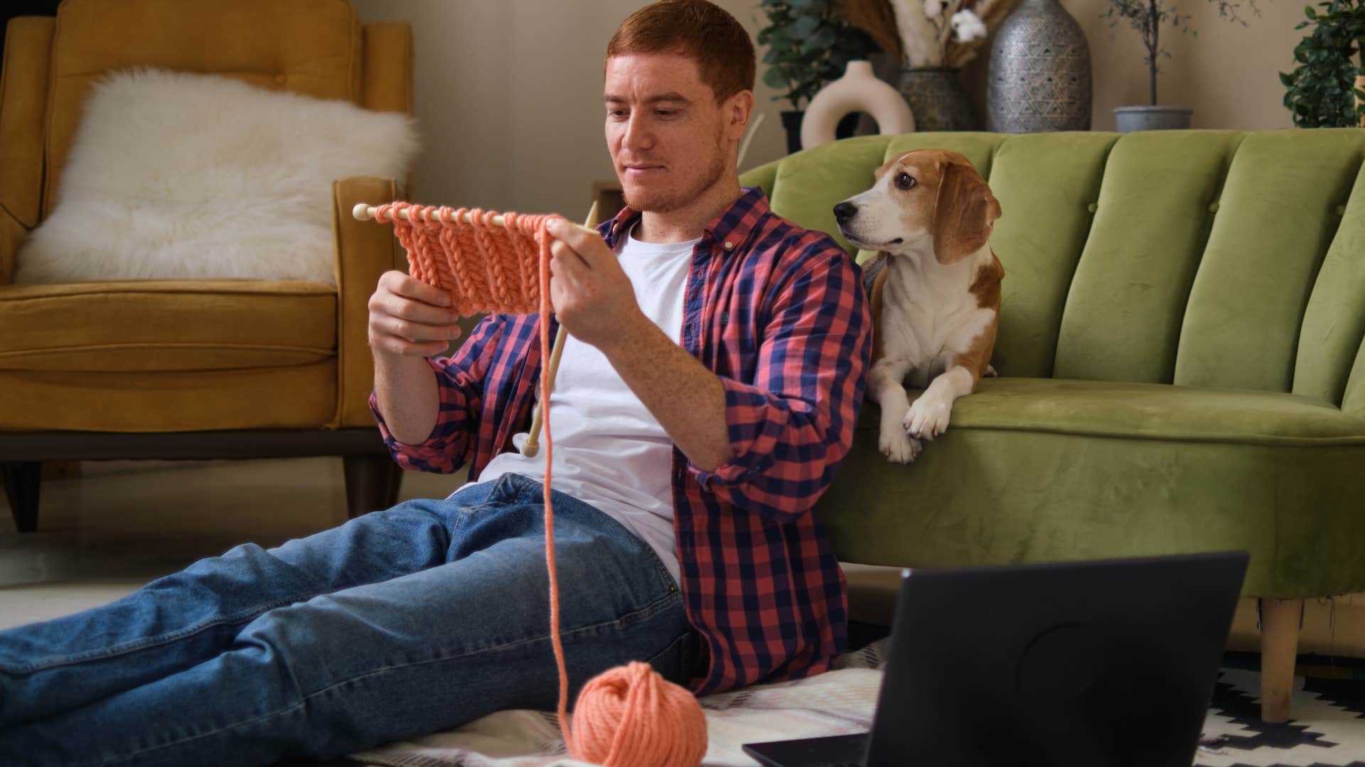 man knitting sitting on the floor