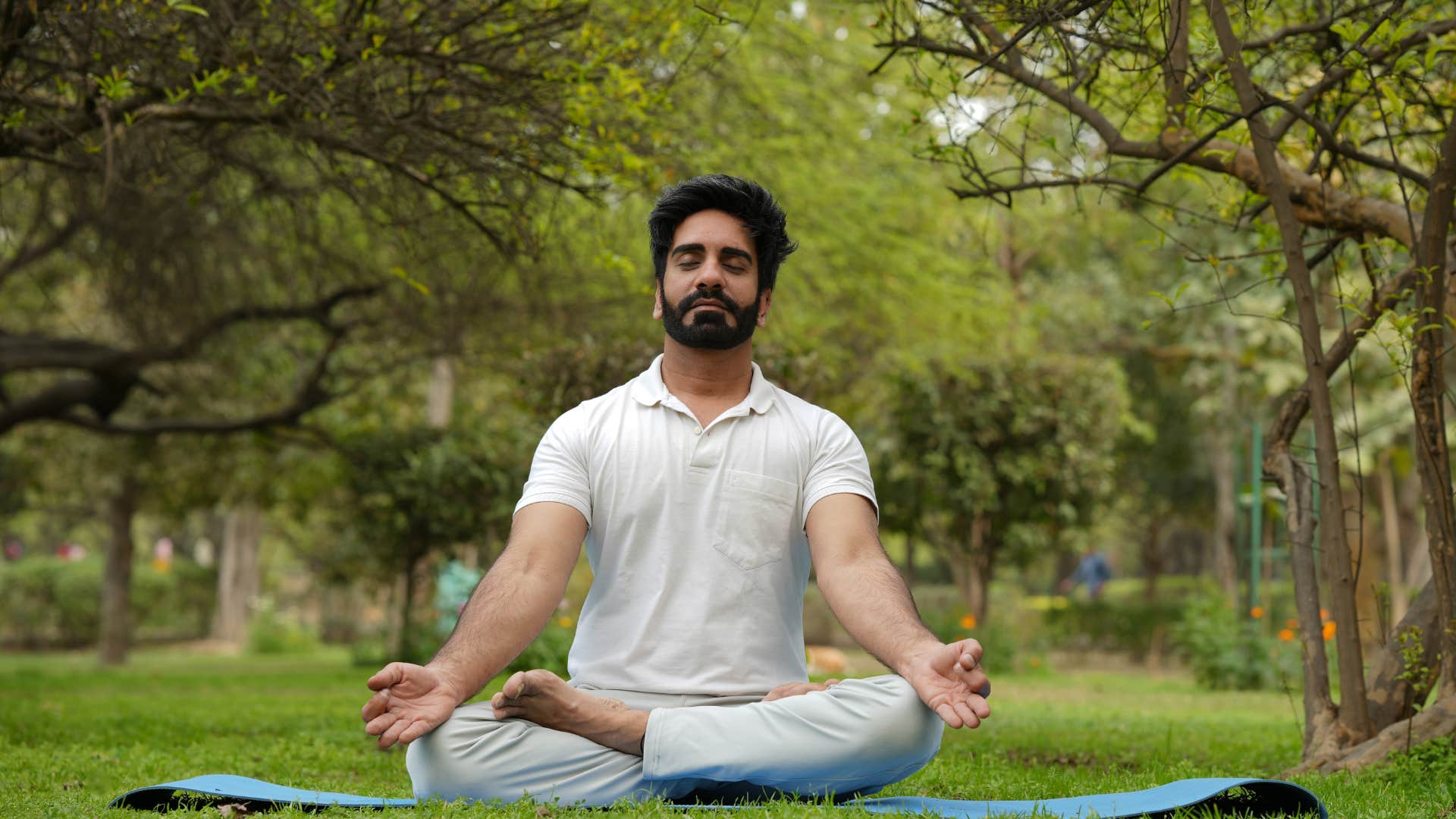 man doing yoga outside