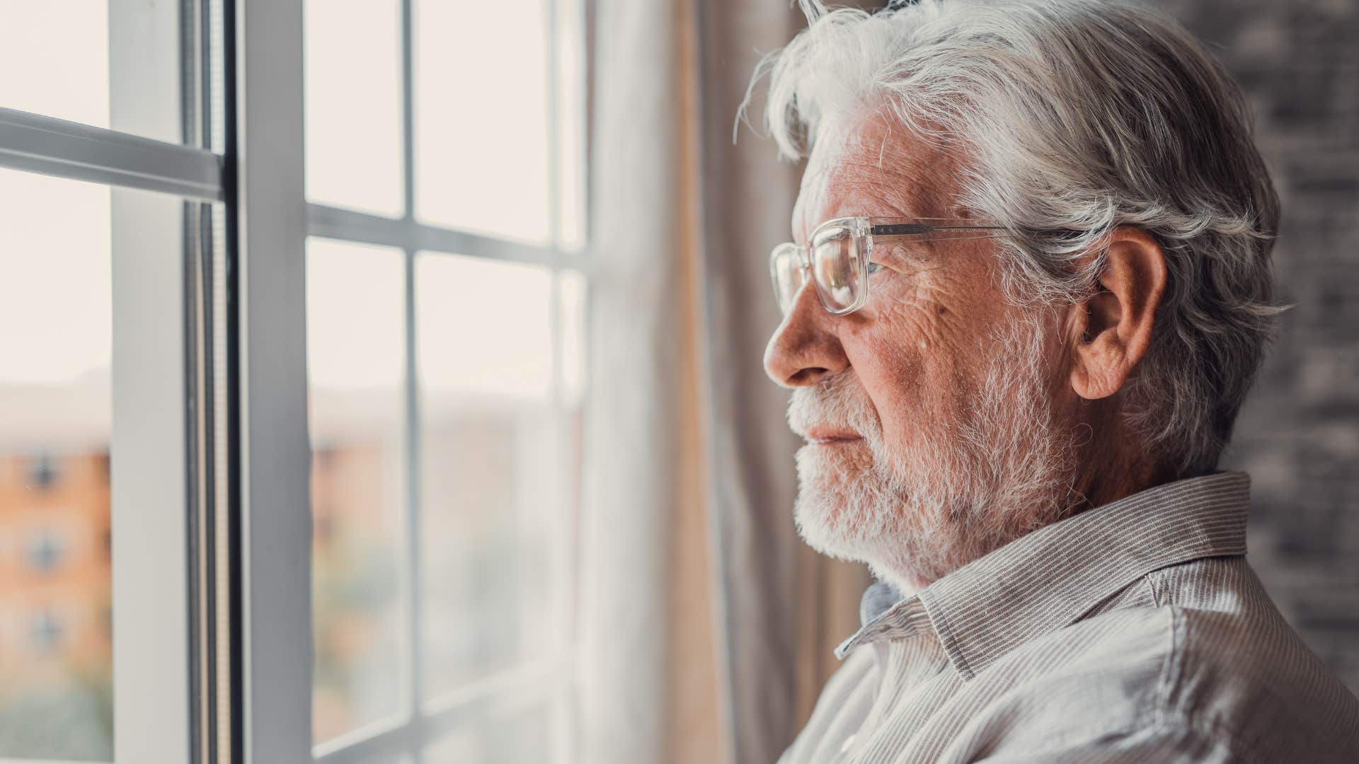 lonely older man who rarely asks for help looking out a window
