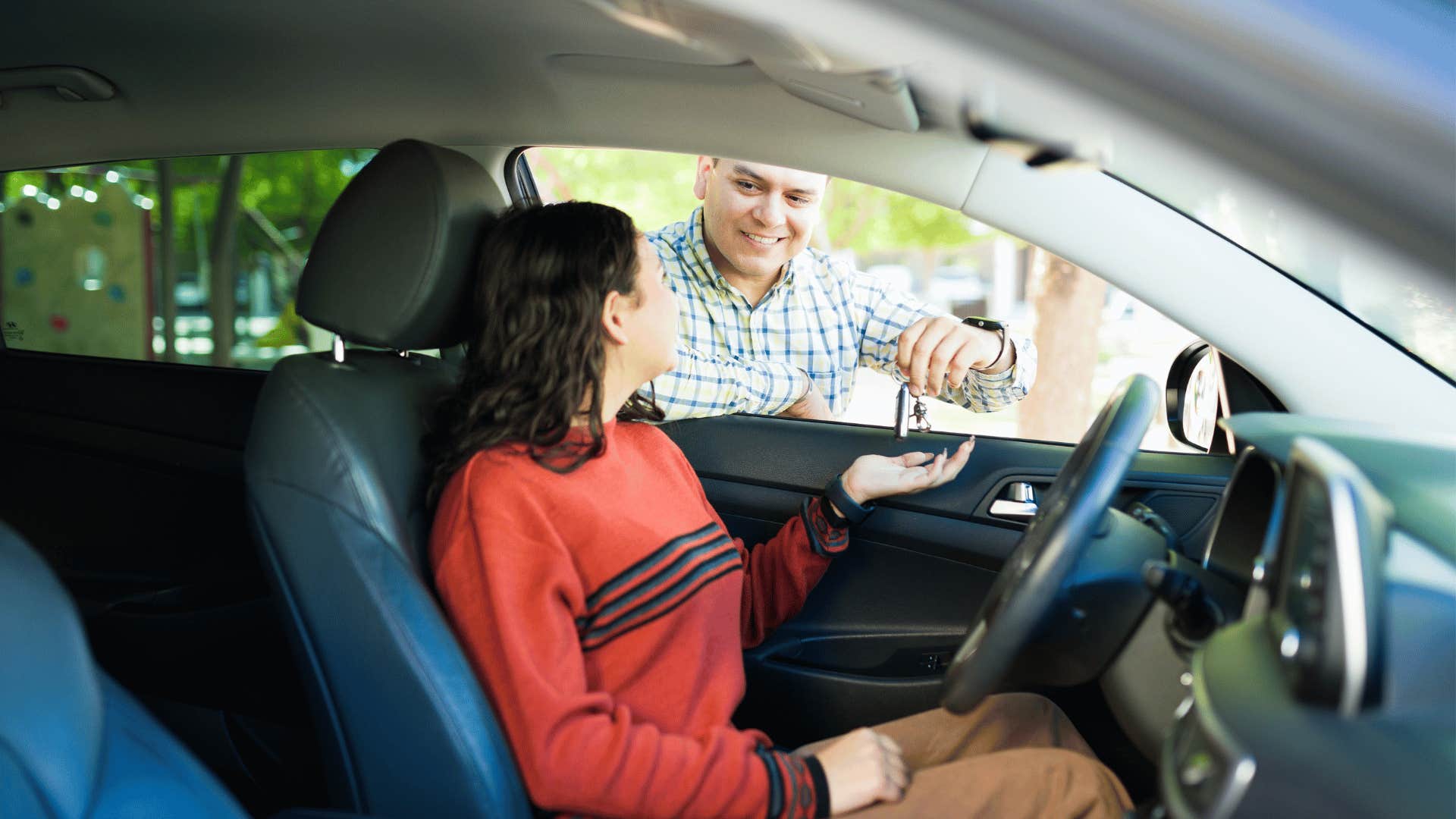 father telling teen daughter to drive safely in car