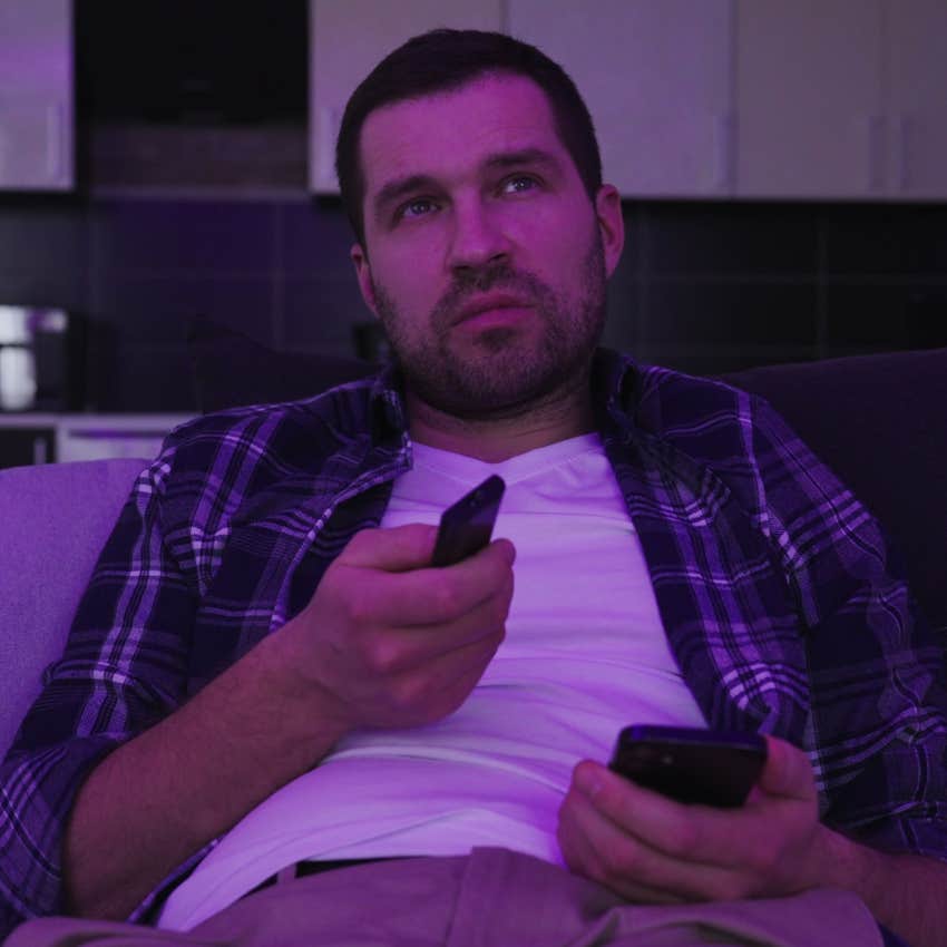 unhappy man mindlessly watching tv using misguided coping mechanisms