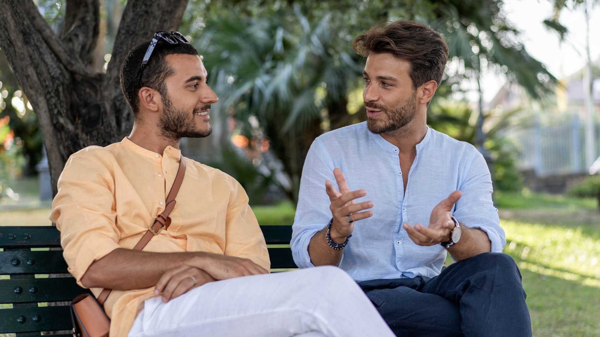 two men gossiping together outside