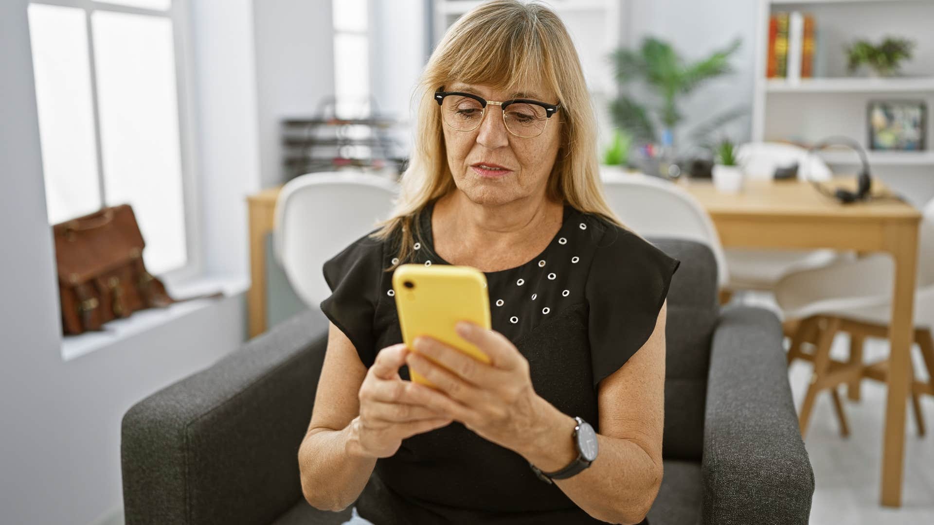 Woman saying "it's been quiet here" on her phone at home.