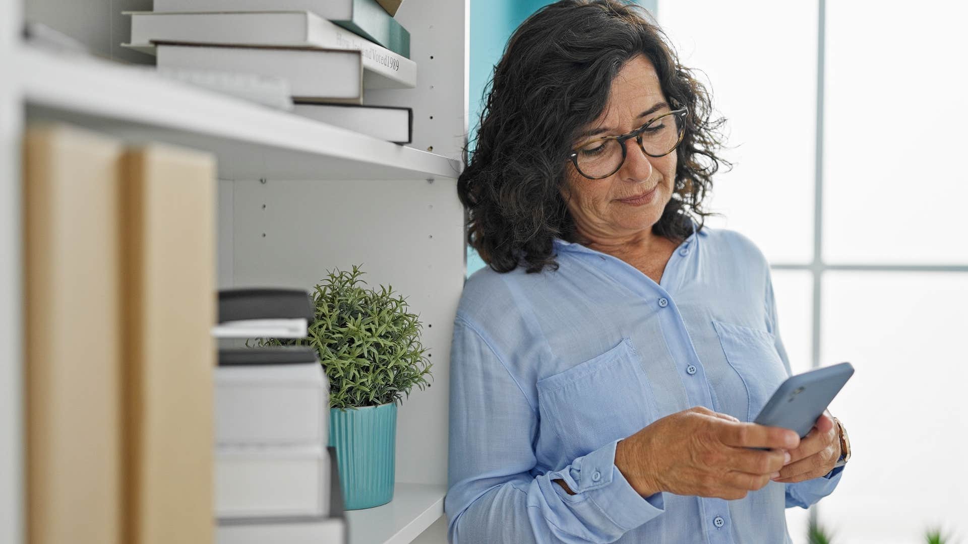 Woman saying "When are you stopped by?" on her phone.