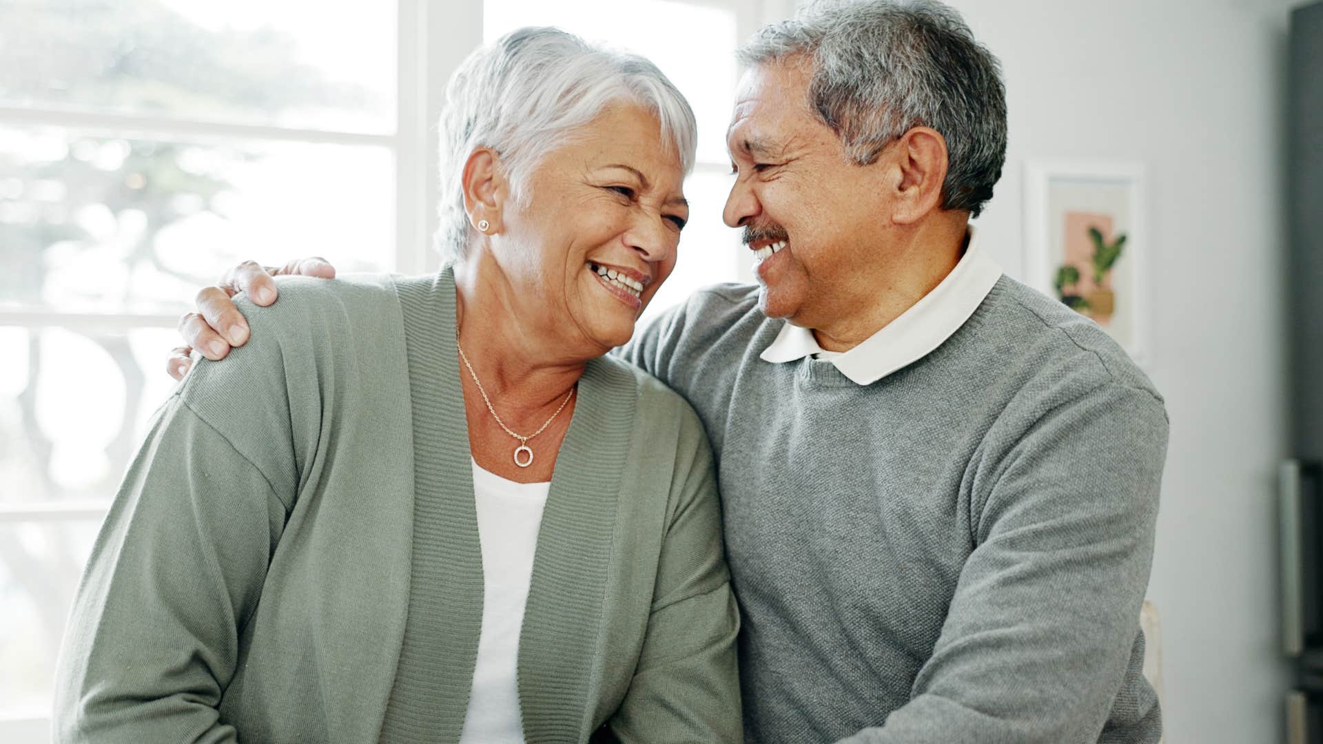 couple smiling with woman saying i trust you to her husband