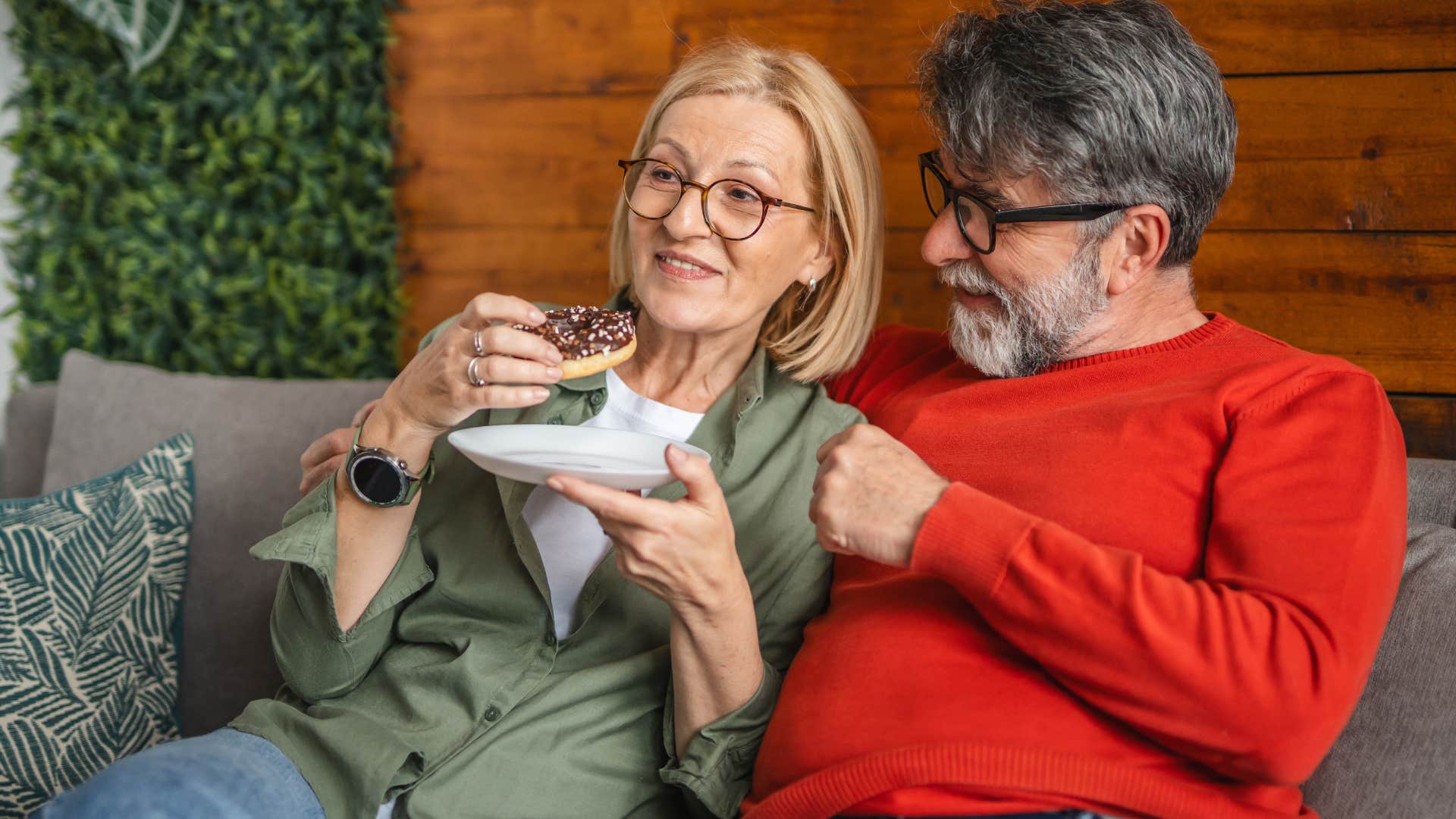 woman saying i'm listening while husband talks to her on the couch