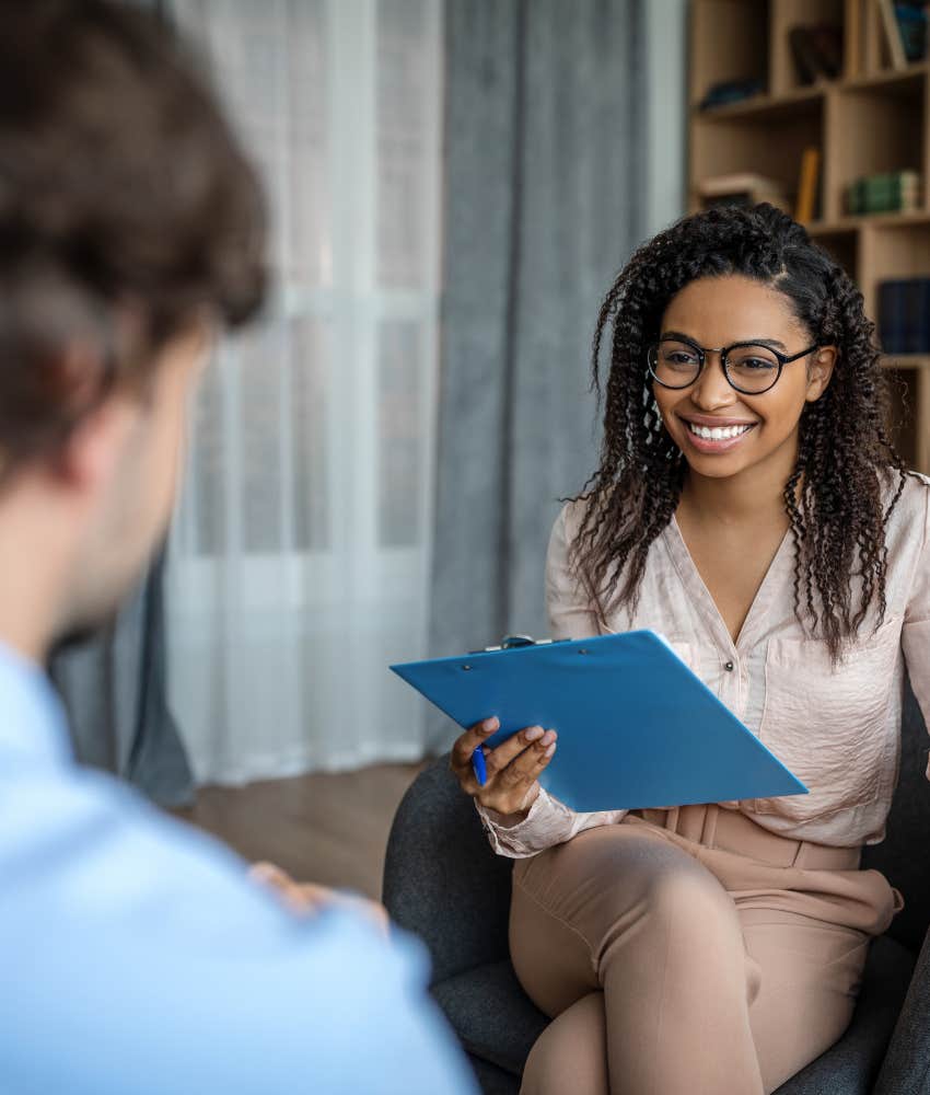 Happy therapist helps anxious person showing way to be calm