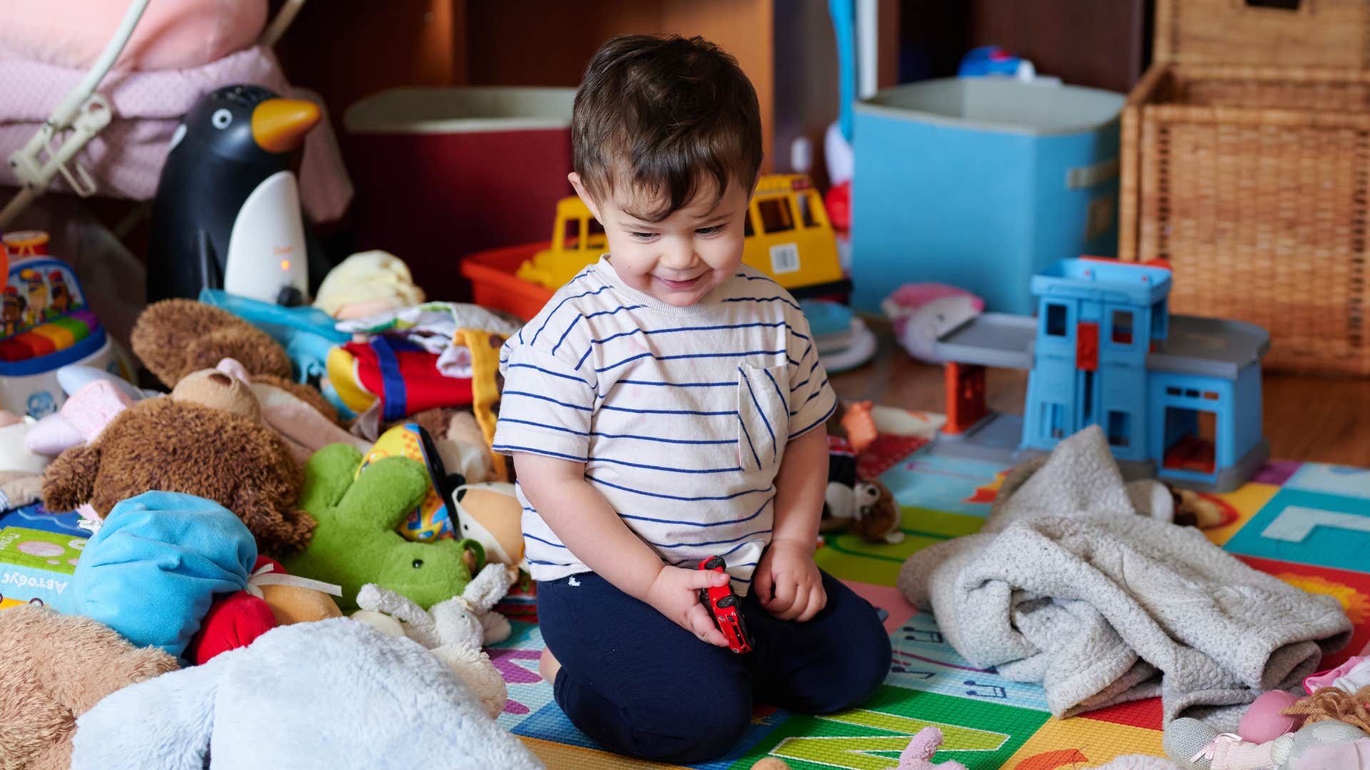 kid surrounded by toys