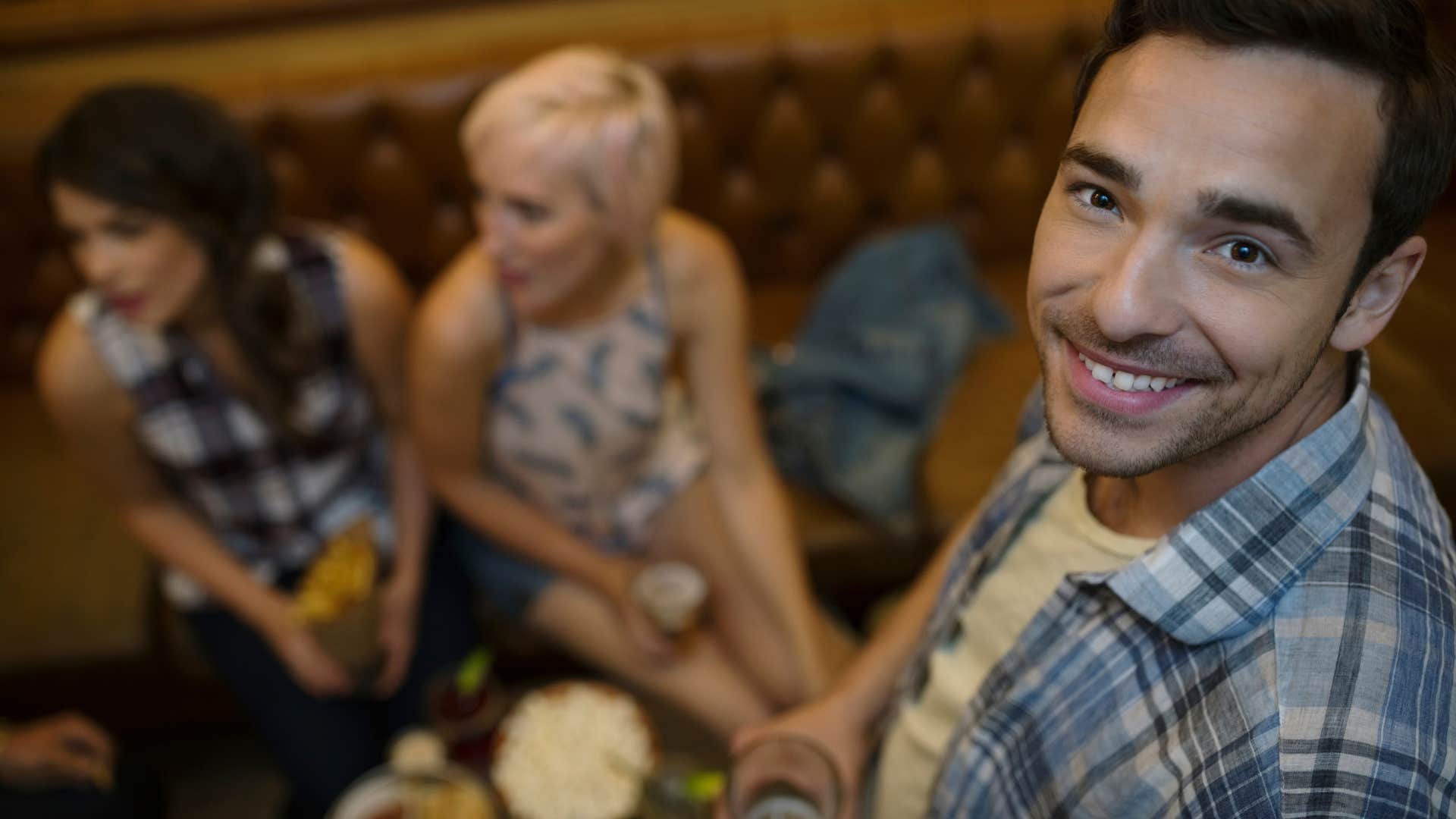 woman who funds man comfort as he hangs out with her friends without her