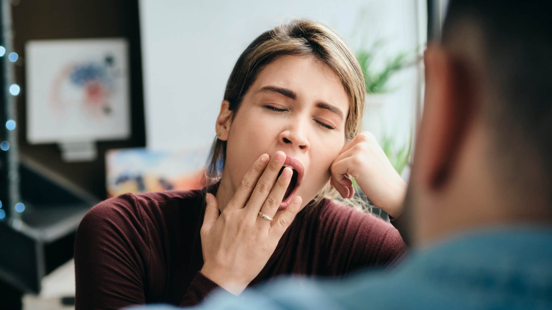 woman yawning being disengaged during talk with husband