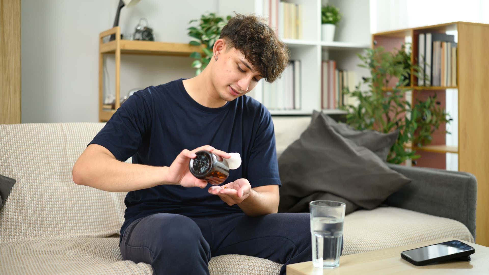 man in black outfit taking supplements