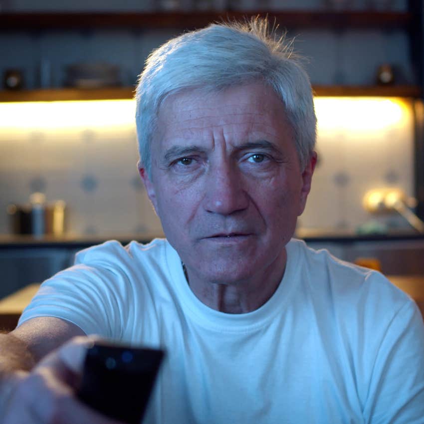 Man battling loneliness watching TV at night.