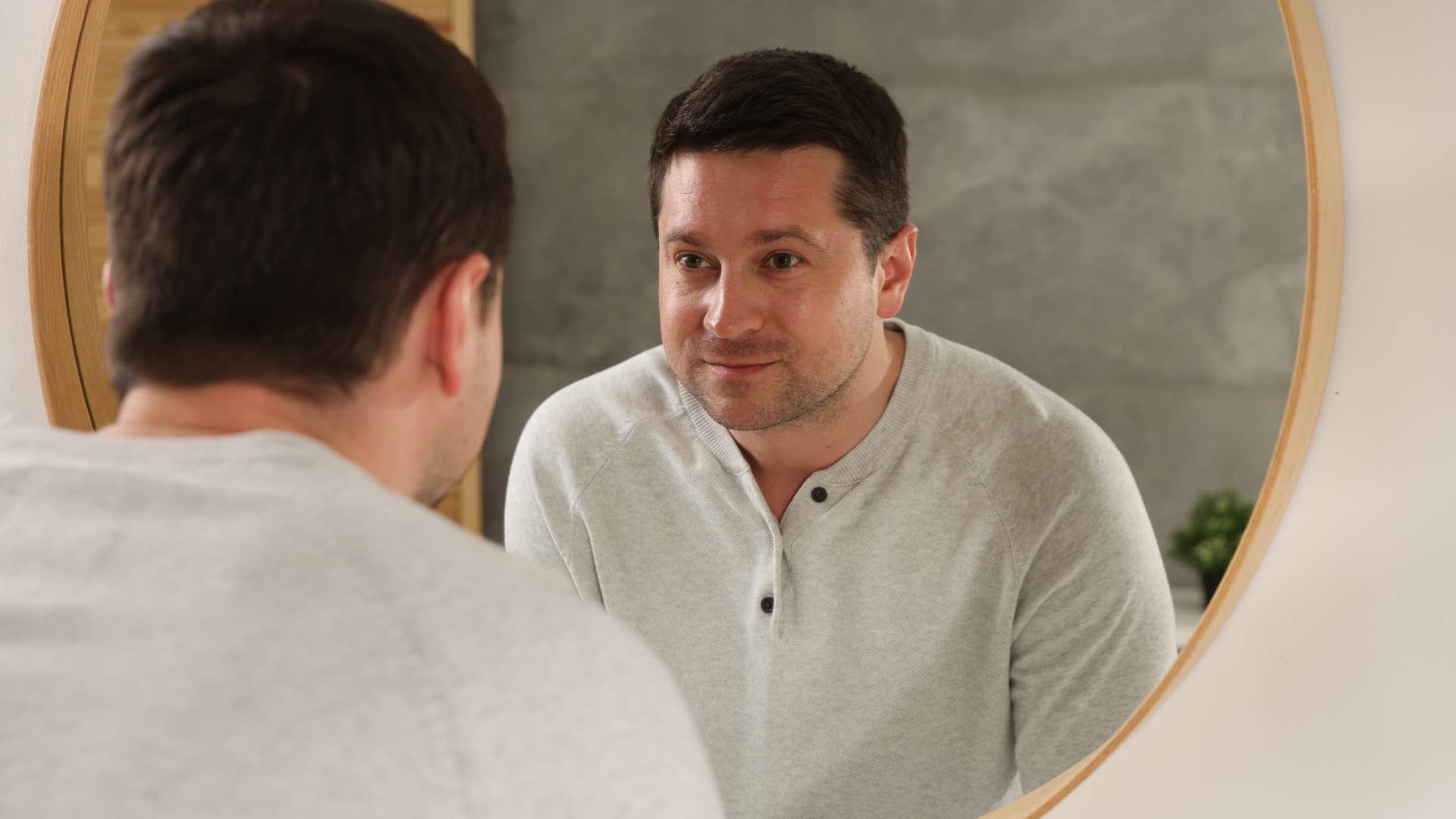 man looking at himself in the mirror