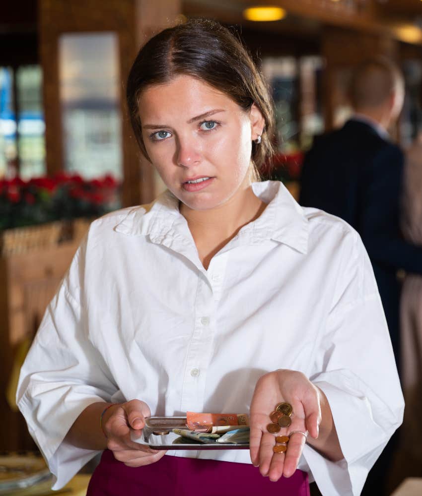 waitress receiving small tip