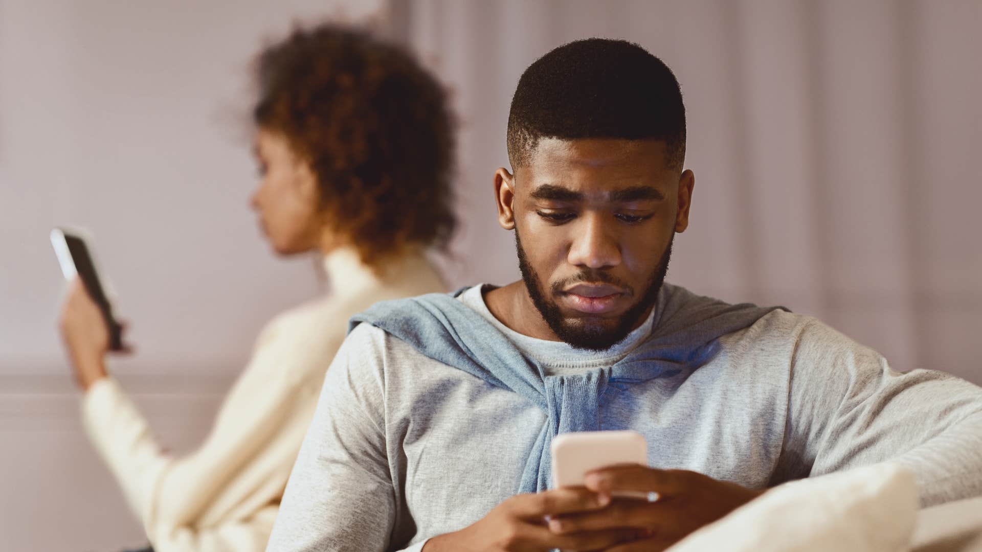 couple on their phones instead of talking
