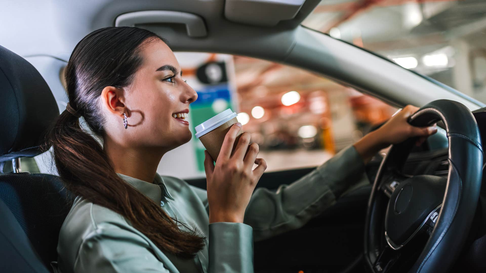 woman drinking coffee drink as she drives everywhere