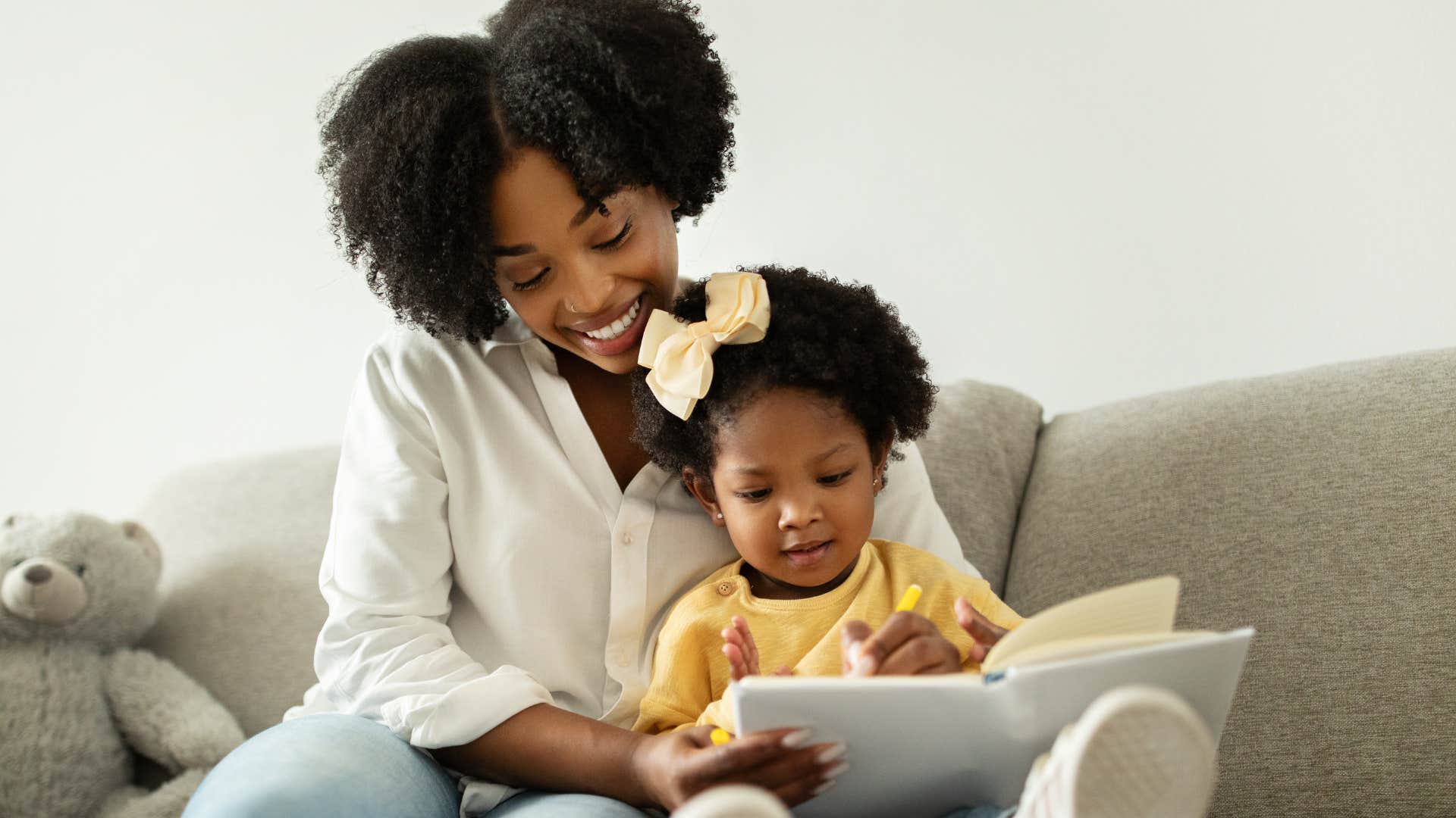 Woman limiting TV time and reading with her daughter at home.