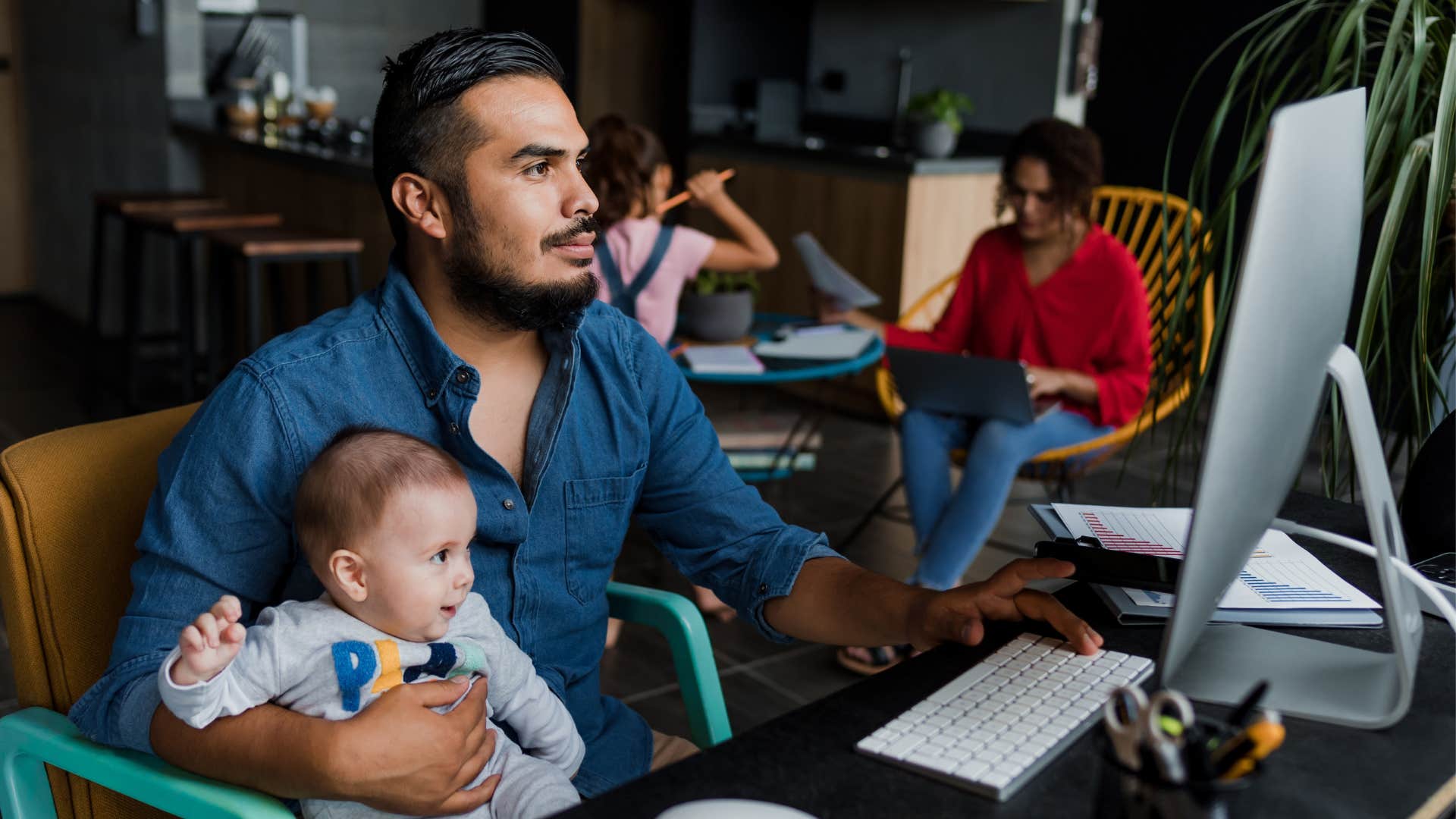 anxious dad sitting with child on the computer