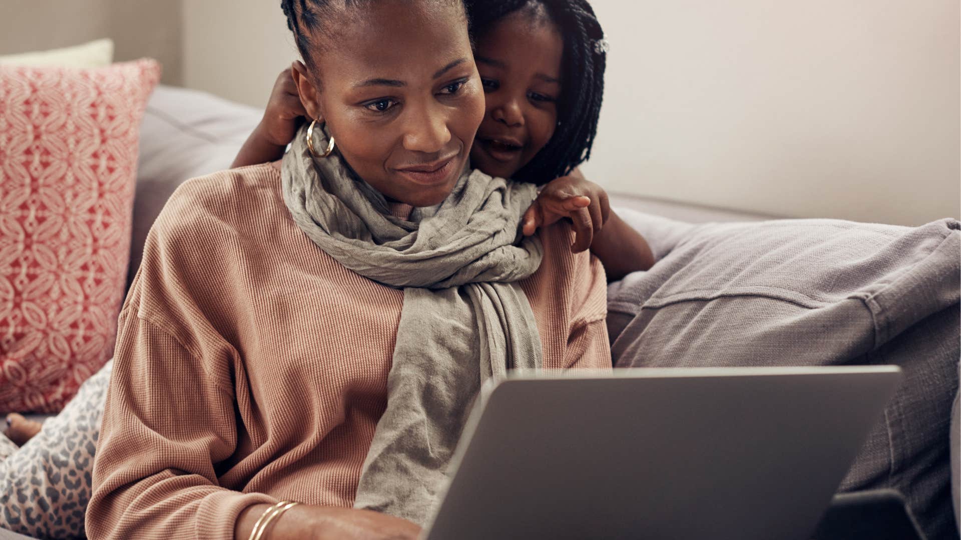mom on the computer with her daughter feeling judged