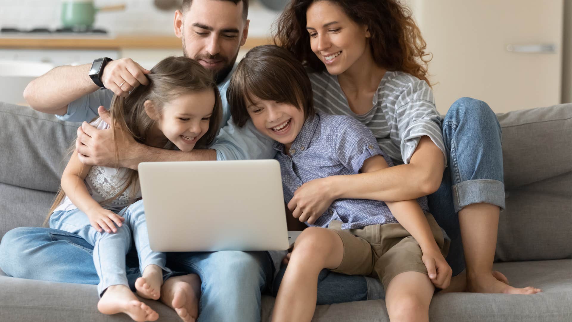 family on the computer together laughing