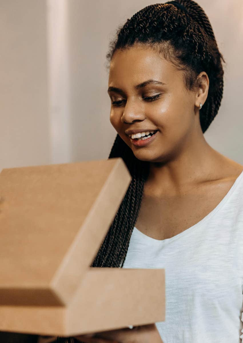 woman opening a gift she is unsure about