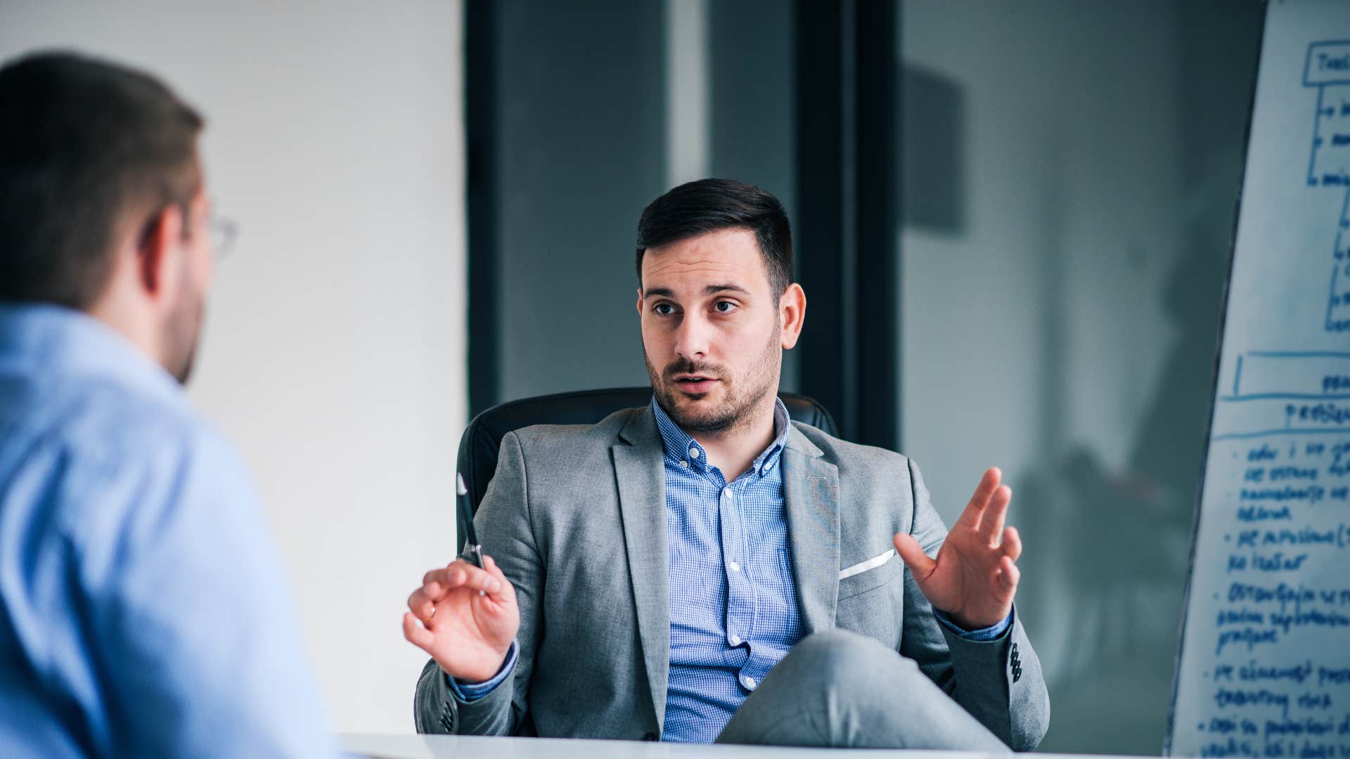man faking intelligence saying i'm not trying to be arrogant but to colleague