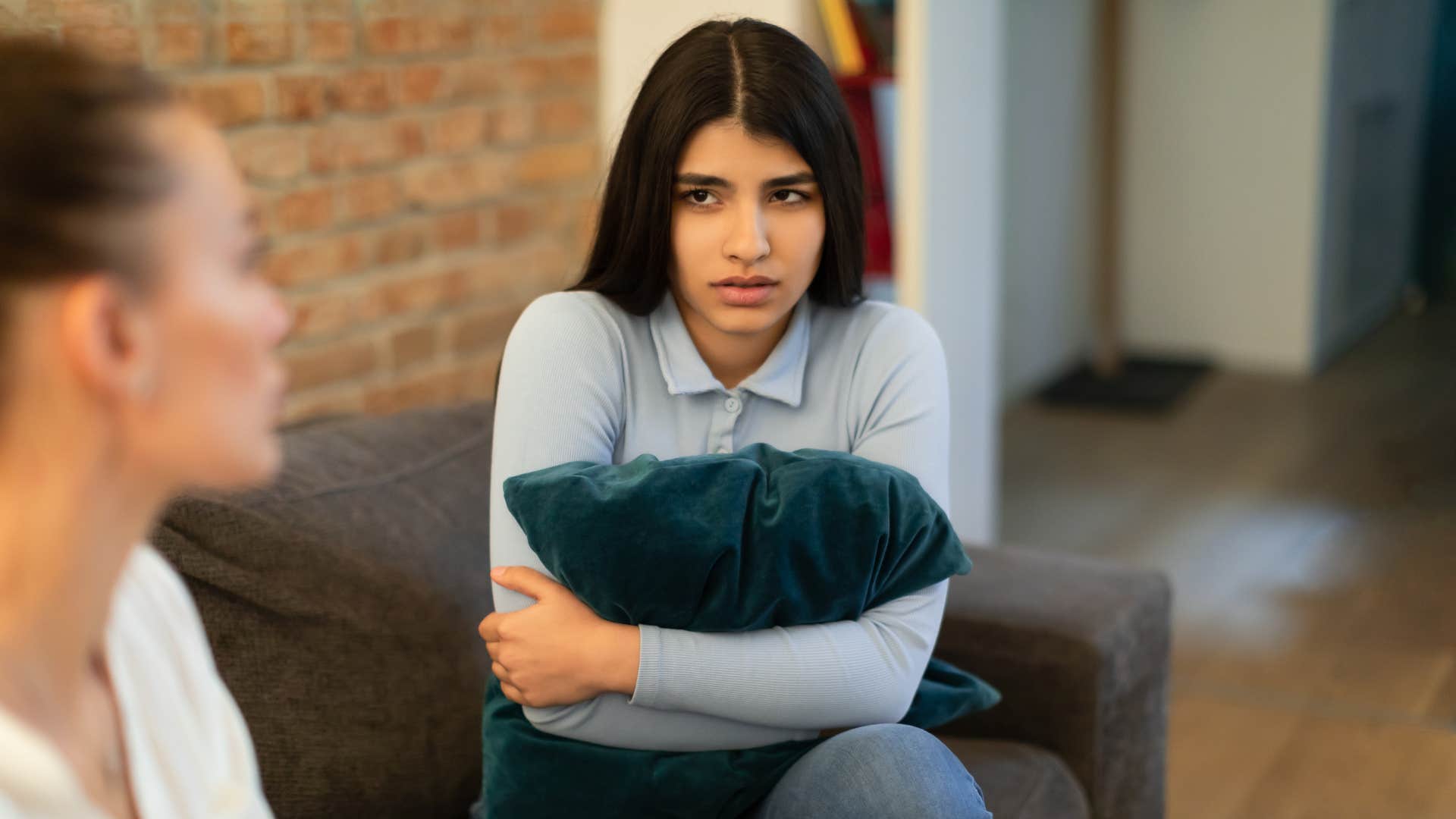 woman clutching pillow being quiet
