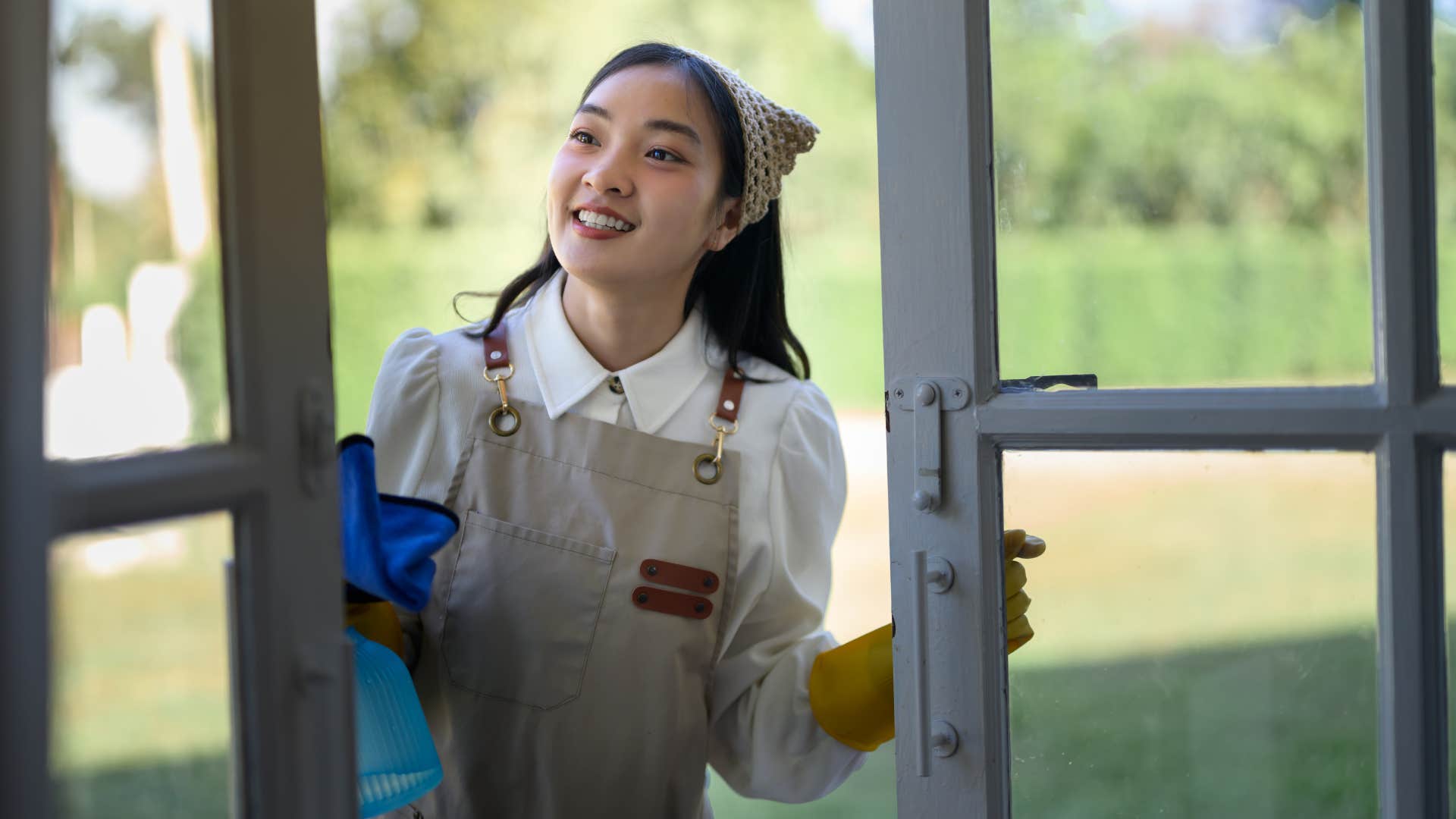 woman opening window cleaning 