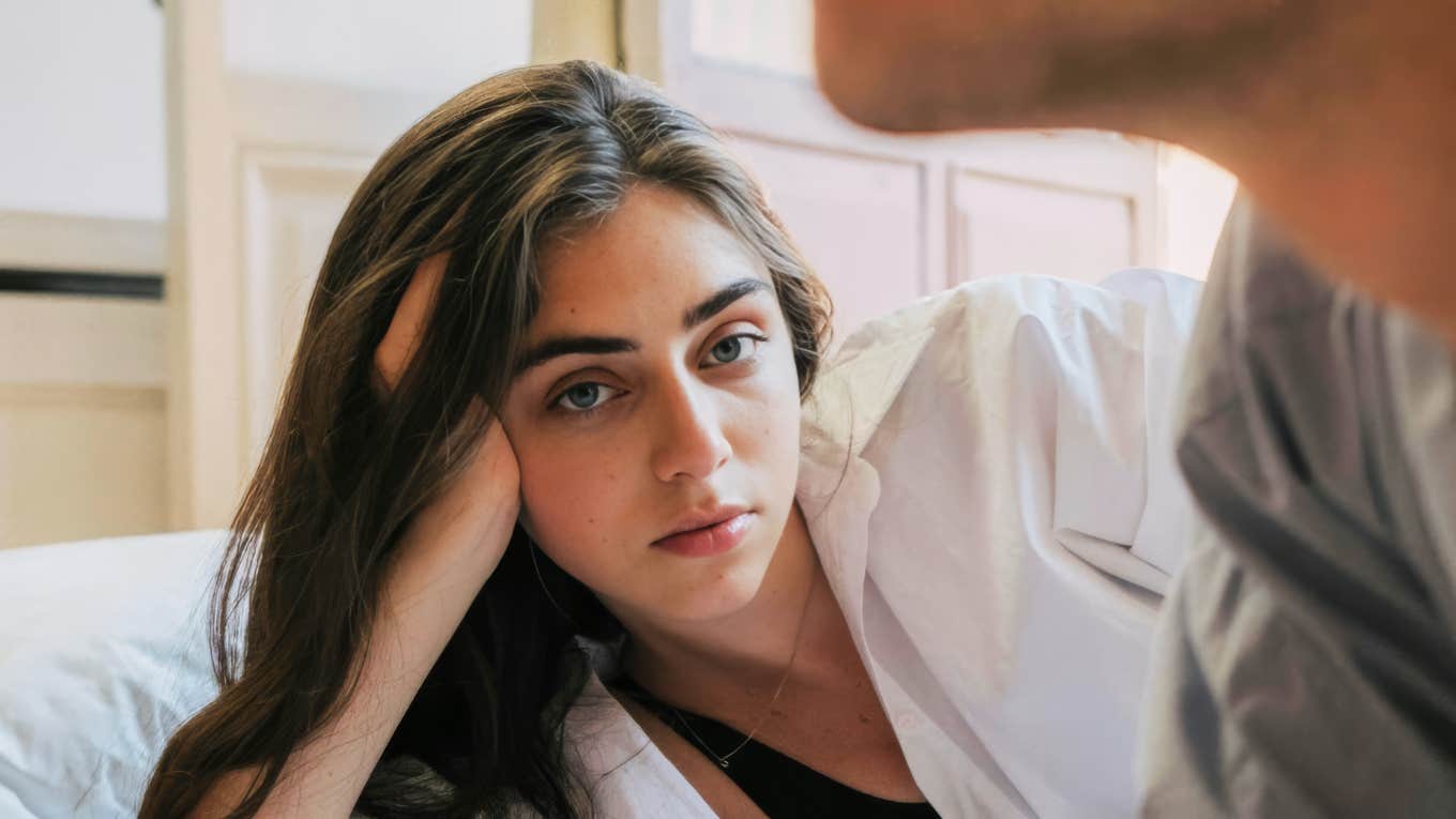 person staring off with quiet dread while their partner feels emotionally distant, capturing the subtle early signs people notice when they kinda know their relationship is already ending