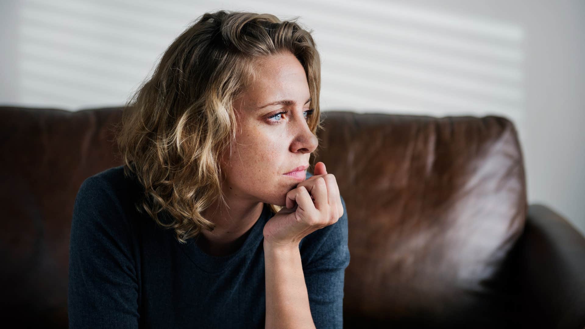 woman punishing herself thinking deeply