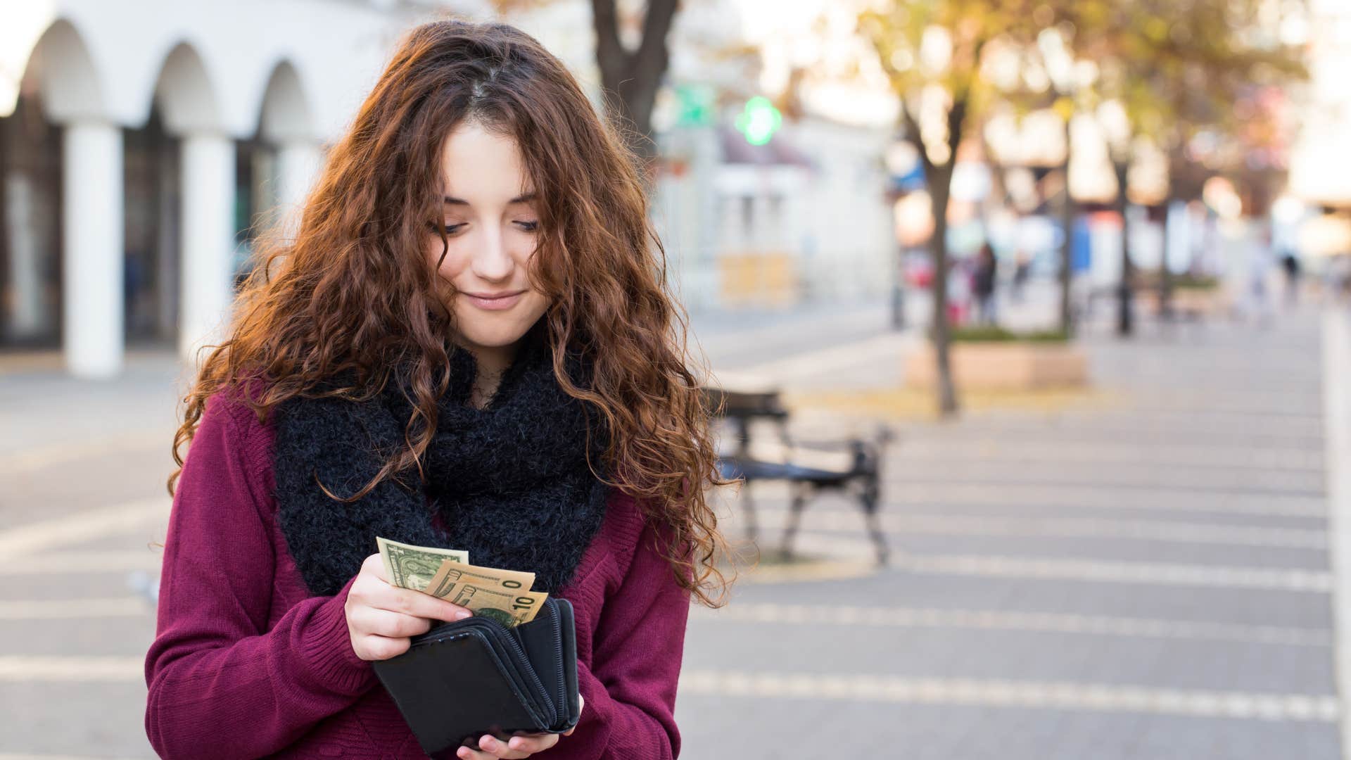 woman holding cash for financial predictability