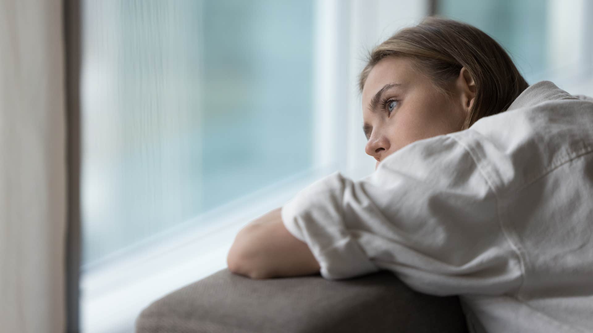 upset woman with a scarcity mindset daydreaming