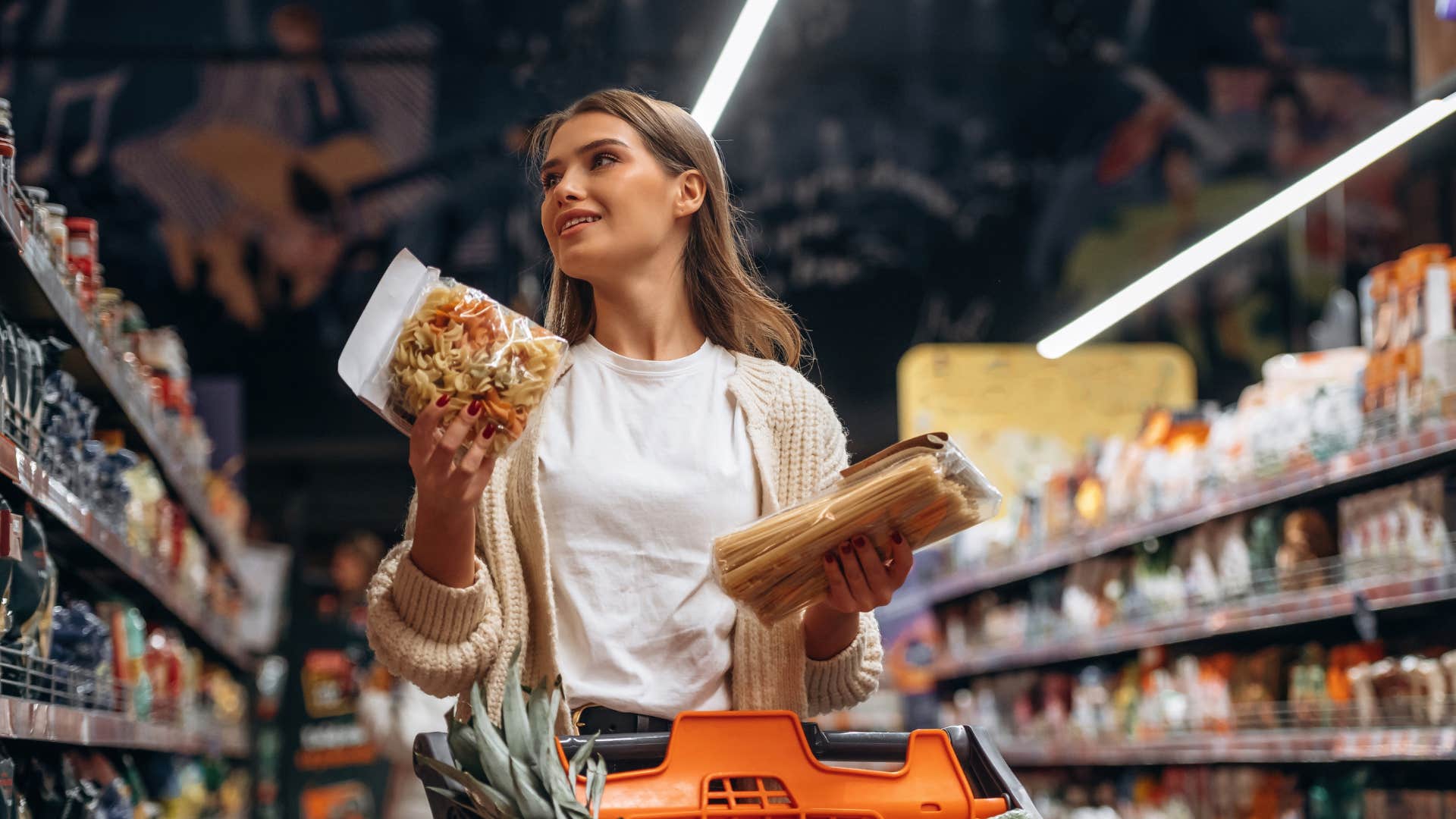 woman looking at food at grocery store