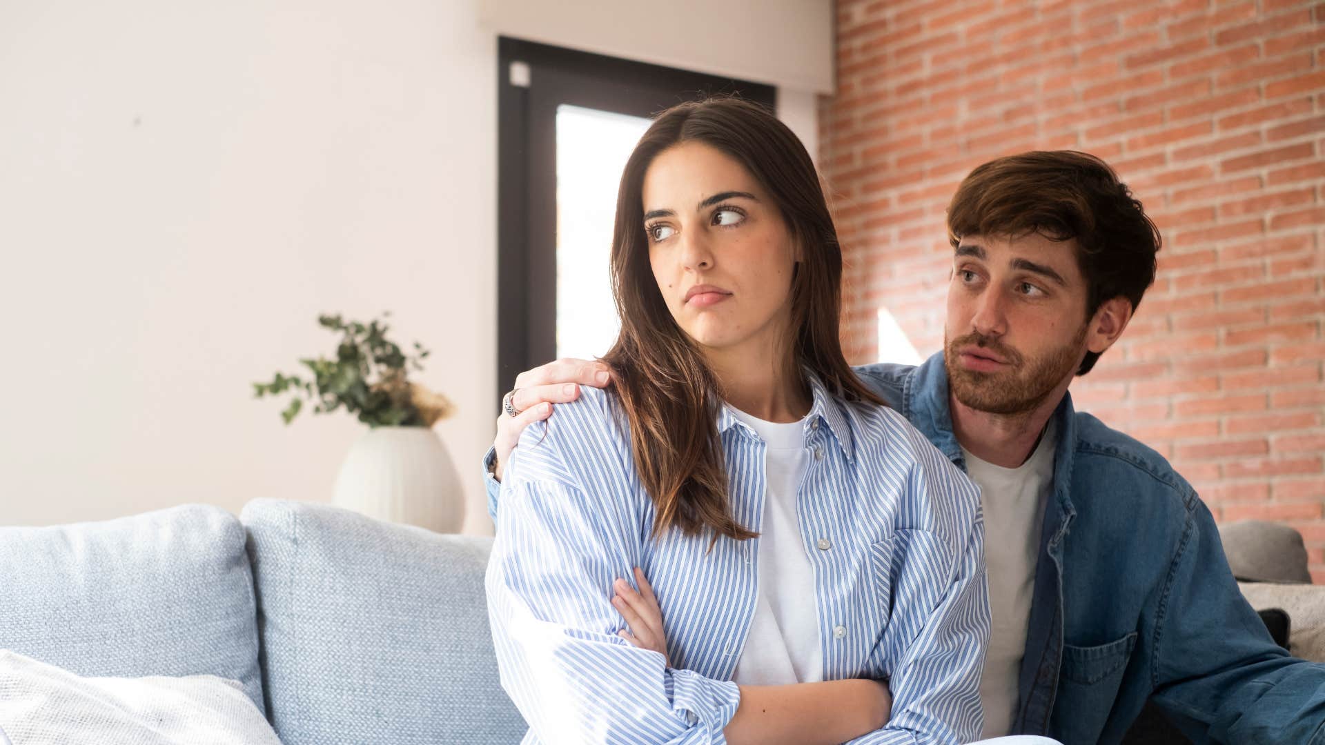 man trying to comfort woman as he tells her my bad i was just joking