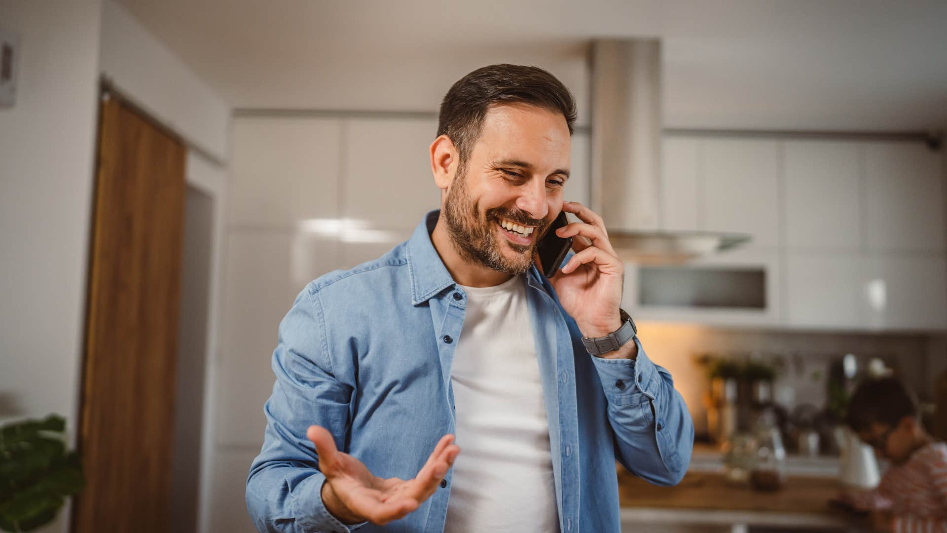 man saying well actually as he's on the phone smiling