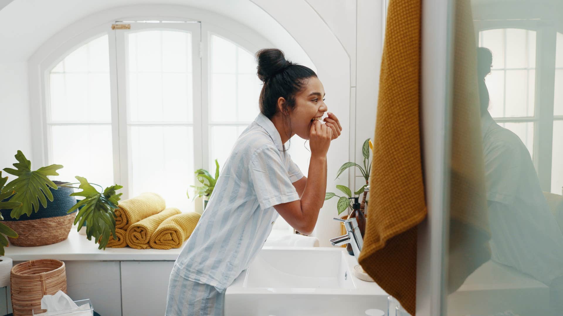 woman doing her skin routine in the bathroom